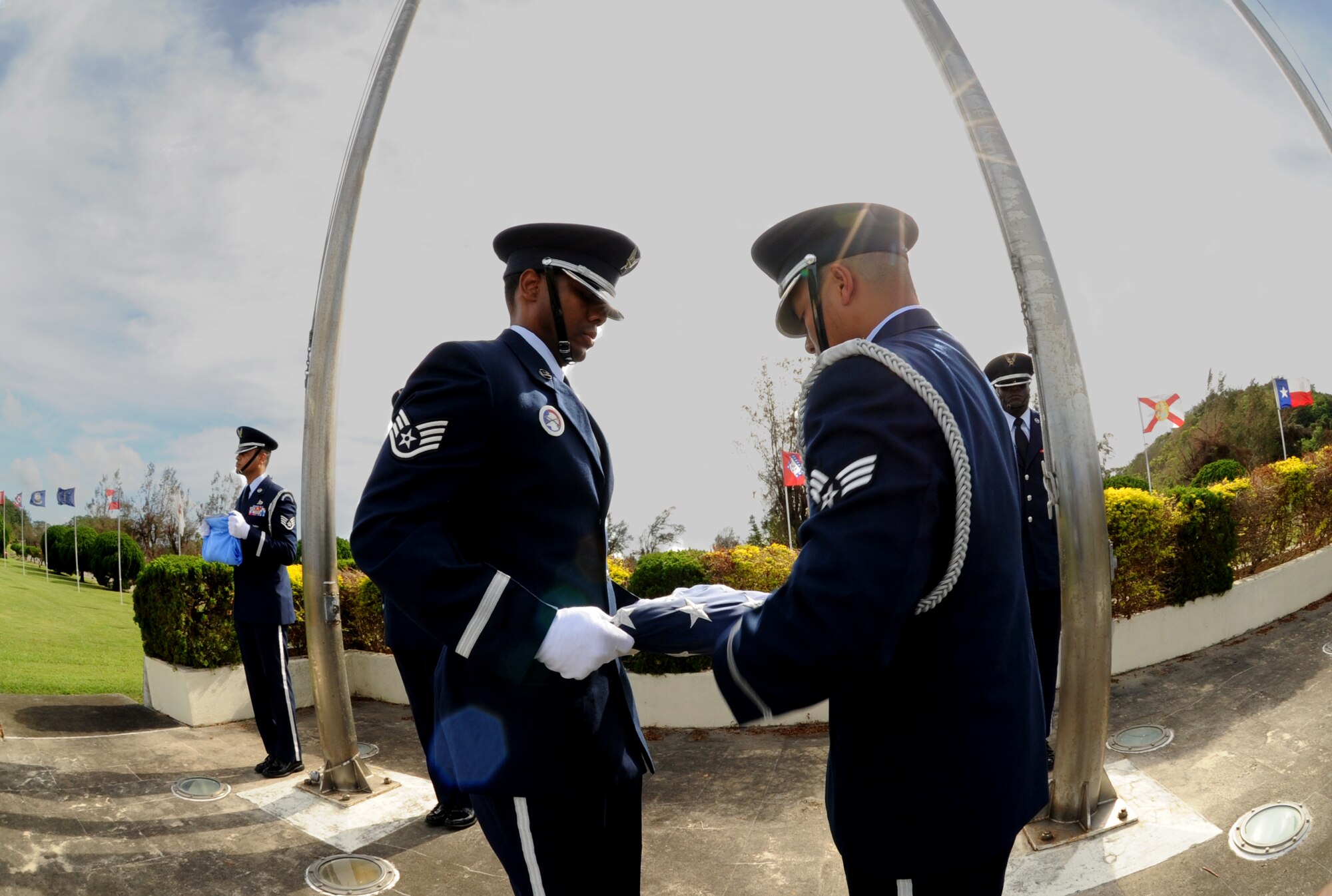 Kadena Honor Guardsmen Staff Sgt. Mario Rainge, 18th Civil Engineer Squadron, and Senior Airman Raymond Firme, 18th Component Maintenance  Squadron, fold the American flag during the 2011 Air Force Sergeants Association’s Flag Day Ceremony, June 14, Kadena Air Base, Japan. During this ceremony unserviceable flags were retired by being burned. (U.S. Air Force photo/Airman1st Class Jarvie Z.Wallace) 