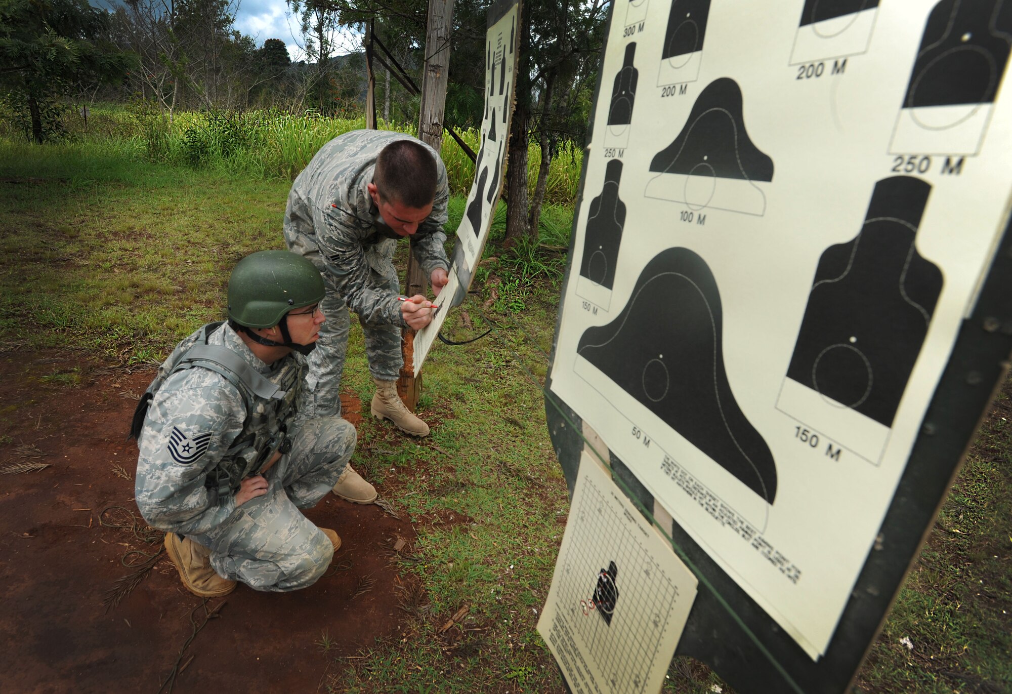 Tech. Sgt. Michael Skonetski, 647th Security Forces Squadron Rodeo team leader, looks on as his shots are counted and scored at the firing range on Scholfield Barracks June 13. The 647th SFS Rodeo team consists of four members who must endure physical and mental challenges to ready themselves for the competition. (U.S. Air Force photo/Senior Airman Lauren Main)