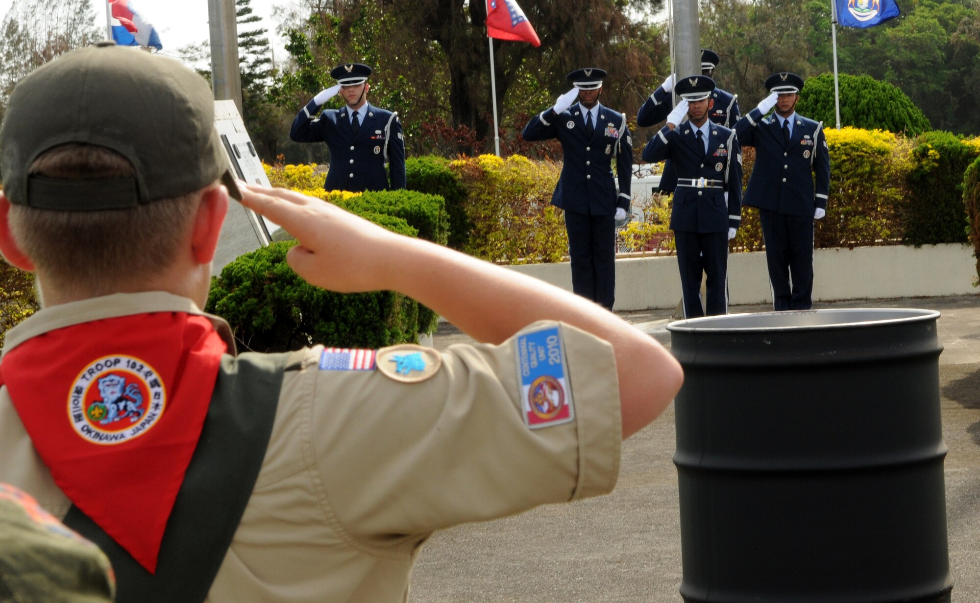 Kadena Airmen as well as Cub Scouts render a salute to the flag while reciting the Pledge of Allegiance during the 2011 Air Force Sergeants Association’s Flag Day Ceremony, June 14. During this ceremony unserviceable flags were retired honorably by being burned. (U.S. Air Force photo/ Airman 1st Class Jarvie Z. Wallace) 