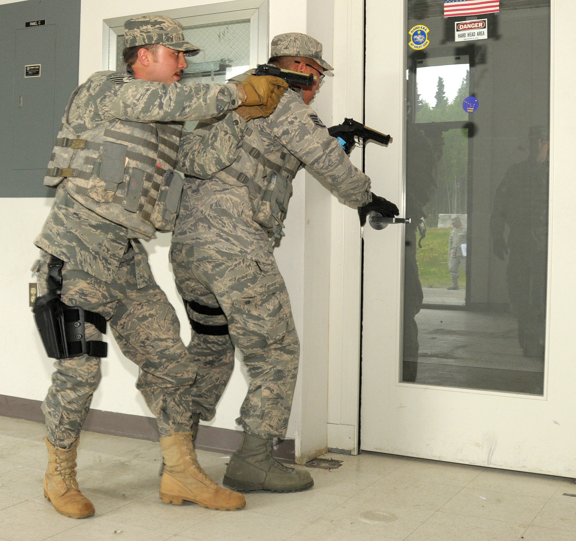 Staff Sergeant Donald Heathcote and Staff Sergeant Jonathon Bass, members of the Security Forces Squadron, 146th Airlift Wing, Channel Islands Air National Guard Station, Calif. prepare to clear a room during an active shooter training scenario conducted by the 176th Air Wing Security Forces Squadron, Alaska Air National Guard, Joint Base Elmendorf- Richardson, Anchorage, Alaska on June 13, 2011. Photo by Tech. Sgt. Alex Koenig