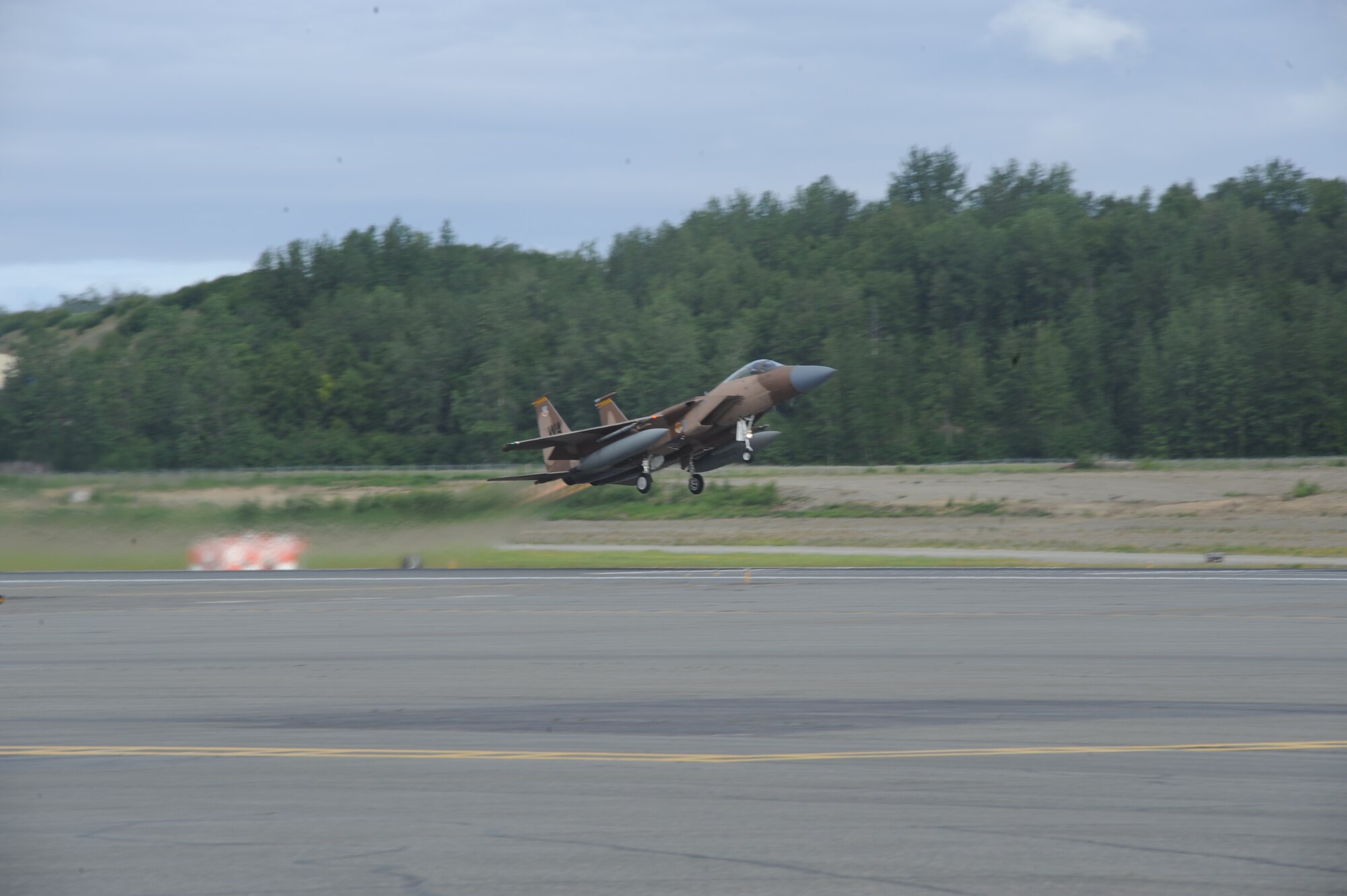 JOINT BASE ELMENDORF RICHARDSON, Alaska --  An F-15 Eagle from the 65th Aggressor Squadron at Nellis Air Force Base, Nev., takes off to participate in the first training mission of Operation Northern Edge 11 in JBER, Alaska, June 13, 2011. Northern Edge, Alaska's largest military training exercise, is designed to prepare joint forces to respond to crises throughout the Asia-Pacific region. (Photo by Mass Communication Specialist 2nd Class Rufus Hucks)