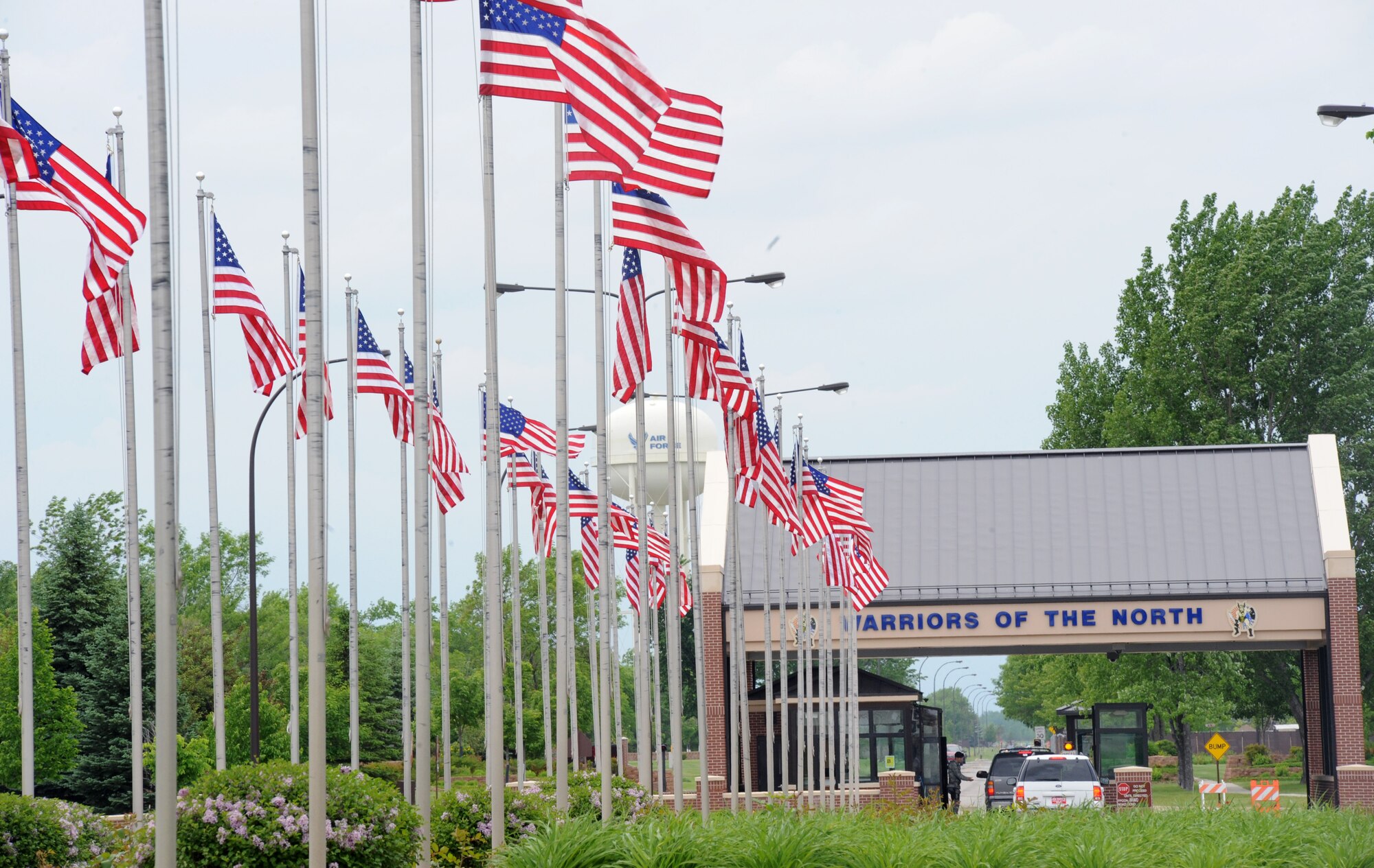 American Flags line the driveway to the main entrance of Grand Forks Air Force Base June 14, 2011, in recognition of United States Flag Day. Flag Day commemorates the adoption of the flag of the United States which originally occurred June 14, 1777. (U.S. Air Force photo by Senior Airman Amber Bennett)
