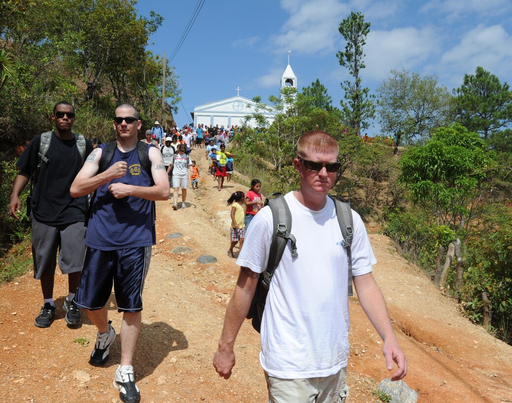 Joint Task Force-Bravo Soldiers, Airmen, Sailors and Marines hike down a hill after delivering bags of food to an isolated village June 11, 2011, near Comayagua, Honduras. More than 120 Joint Task Force Bravo personnel hiked two miles up steep terrain to deliver food to people living in the town. (U.S. Air Force photo/Tech. Sgt. Matthew McGovern)