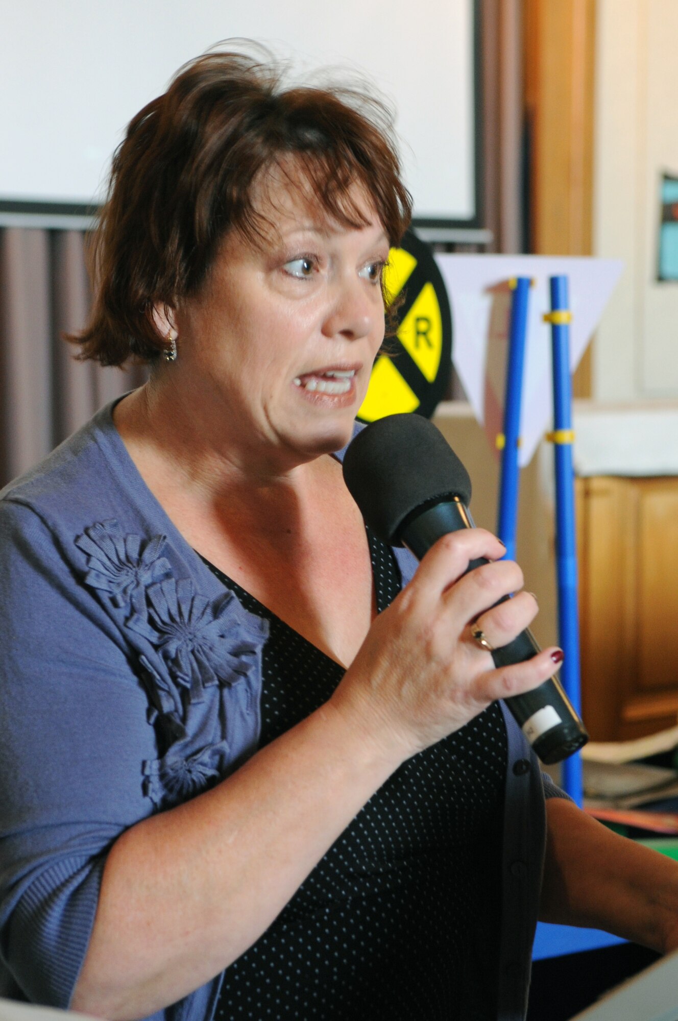 VANDENBERG AIR FORCE BASE, Calif. -- Diane Banner, from the Wing Chapel, gives the children the “Word on the Street” during a Vacation Bible School class here Tuesday, June 14, 2011. This year’s “Inside Out & Upside Down on Main Street” themed VBS uses parables to connect a Bible story and verse to the Word on the Street. Children of all religious backgrounds are invited to attend. (U.S. Air Force photo/Jerry E. Clemens, Jr.)