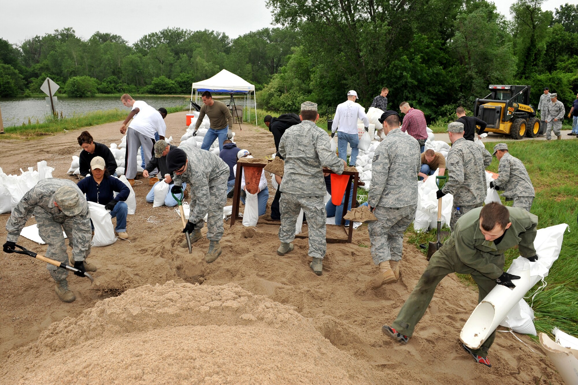 Team Offutt volunteers fill sandbags in Bellevue, Neb., June 10 in preparation to strengthen levees that protect the base. Approximately 350,000 sandbags were filled and laid along the Missouri River and Papio Creek to prevent floodwaters from impacting base facilities. (U.S. Air Force Photo Charles Haymond/Released)
