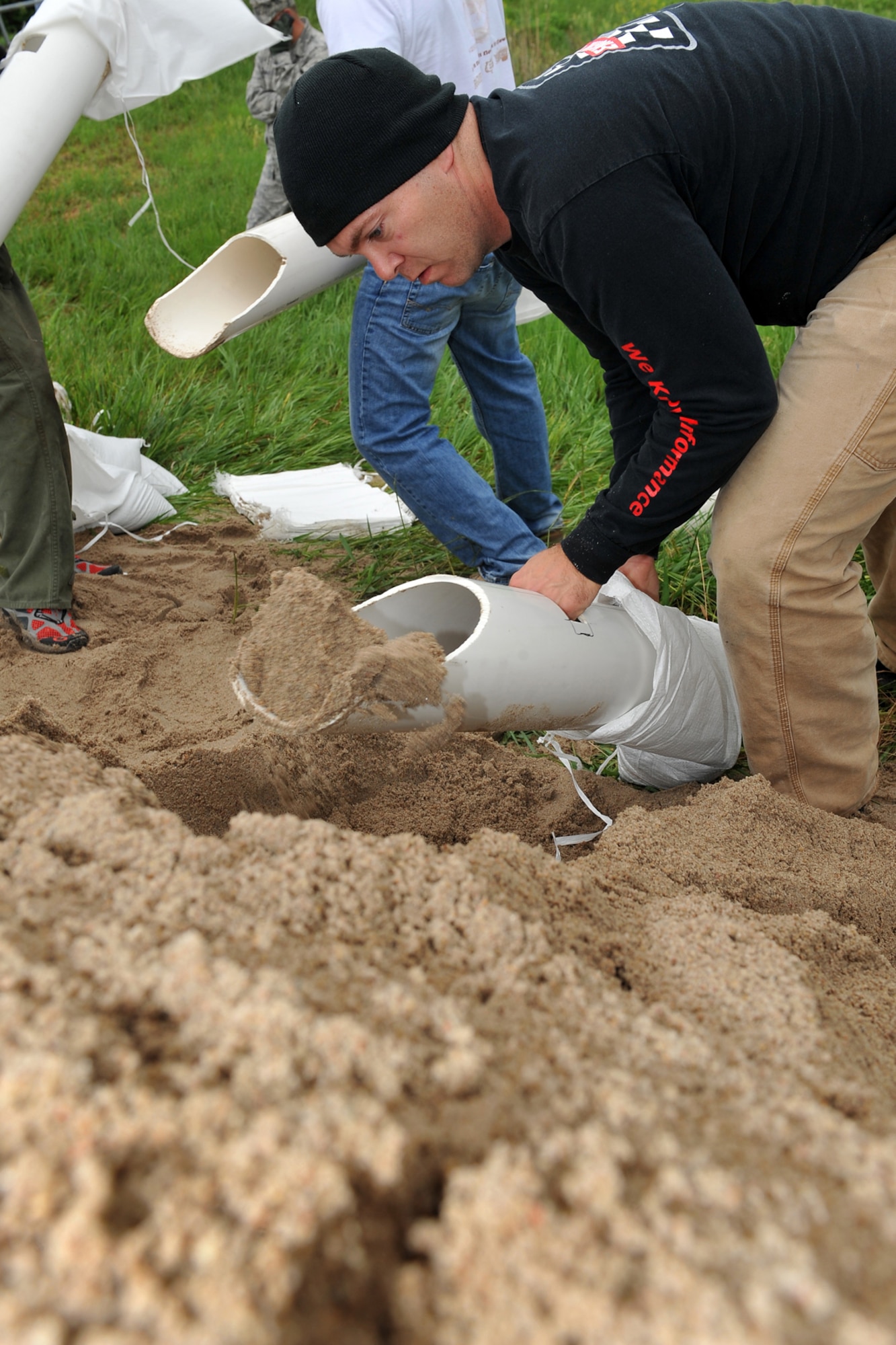 U.S. Air Force Tech. Sgt. Nathan Stuch, weapon system coordinator with the 373rd Training Squadron, fills sandbags in Bellevue, Neb., June 10 in preparation to strengthen levees that protect the base. Team Offutt volunteers filled and laid 350,000 sandbags along the Missouri River and Papio Creek to prevent floodwaters from impacting base facilities. (U.S. Air Force Photo by Charles Haymond/Released)