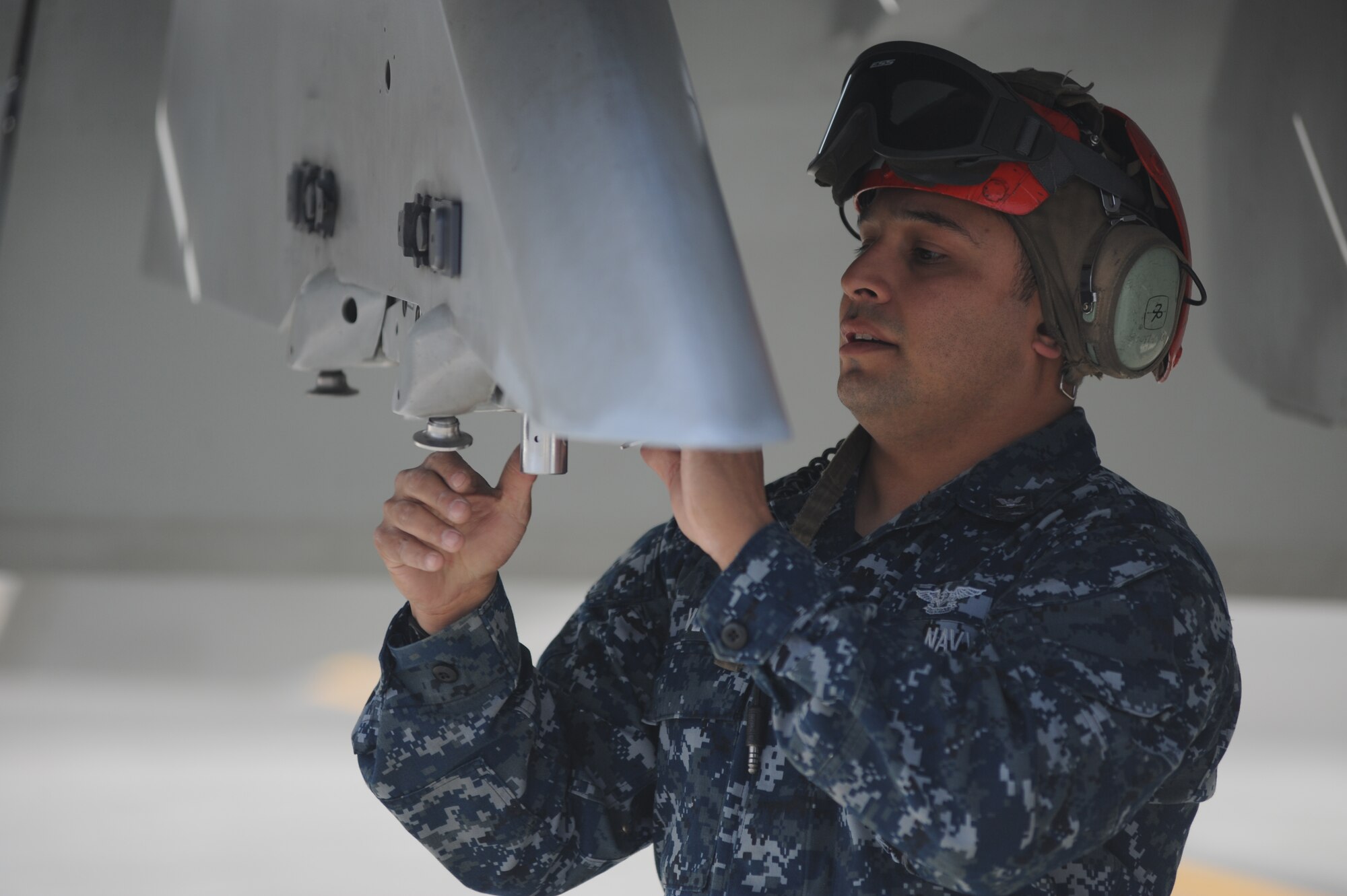 JOINT BASE ELMENDORF RICHARDSON, Alaska --  Aviation Ordnanceman Third Class Chris Vega performs pre-flight checks on an F/A-18F Super Hornet prior to it's first flight in support of Operation Northern Edge 11 in JBER, Alaska, June 13, 2011. Northern Edge, Alaska's largest military training exercise, is designed to prepare joint forces to respond to crises throughout the Asia-Pacific region. (Photo by Mass Communication Specialist 2nd Class Rufus Hucks)
