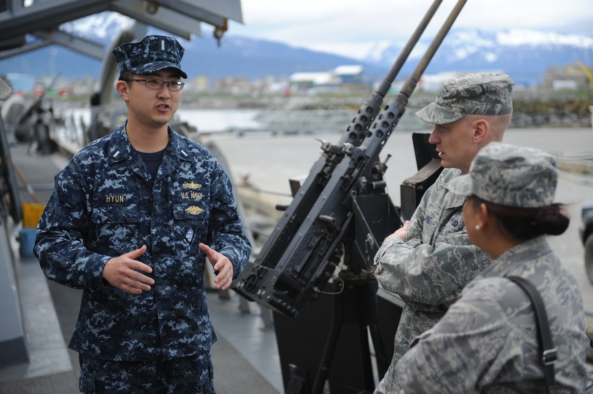 Navy 1st Lt. Rene Hyun gives a tour of the USS Decatur (DDG-73) to Air Force Cpt. Uriah Orland and Lt. Col. Tracey Saiki before the start of Operation Northern Edge 11 in Homer, Alaska, June 12, 2011. Decatur is deployed to Alaska in support of Northern Edge, Alaska's largest military training exercise. The exercise is designed to prepare joint forces to respond to crises throughout the Asia-Pacific region. (Photo by Mass Communication Specialist 2nd Class Rufus Hucks)