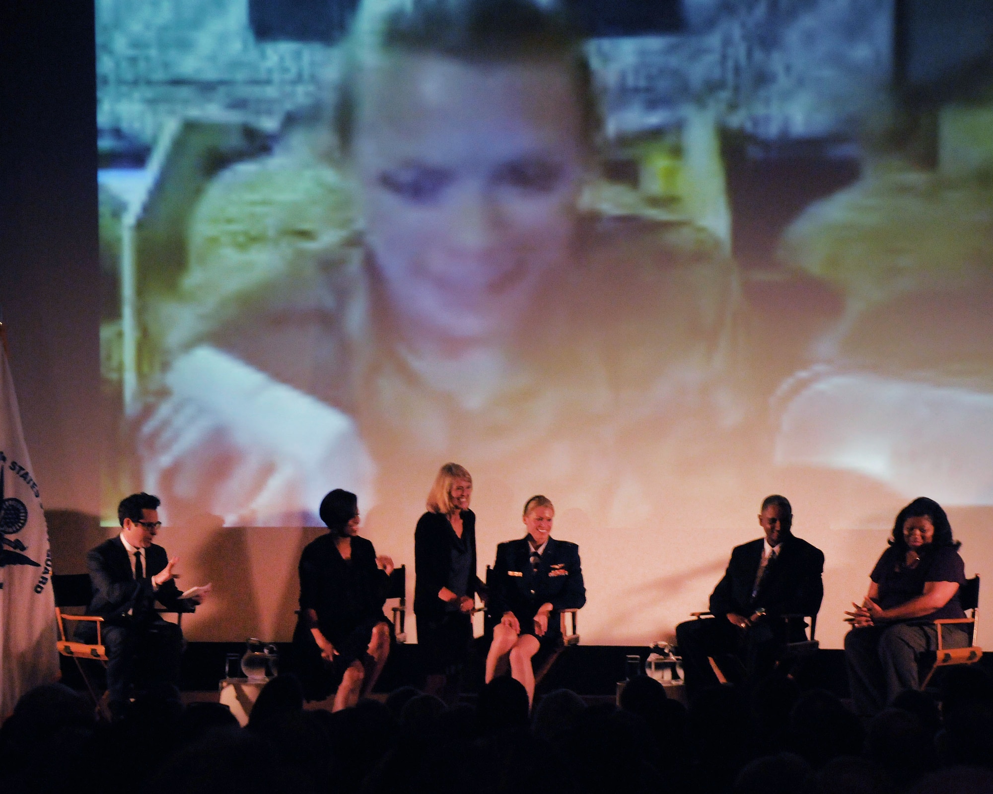 Capt. Kelly Smith, C130 pilot with the 146th Airlift Wing, receives a surprise "skype" visit with her sister next to First Lady Michelle Obama during a panel discussion held June 13, 2011 at the Writers' Guild Theater in Beverly Hills. The First Lady asked writers and producers in the film industry to support the military and their families by sharing their compelling stories and using them in their plotlines. (Photo by Master Sgt. Dave Buttner)