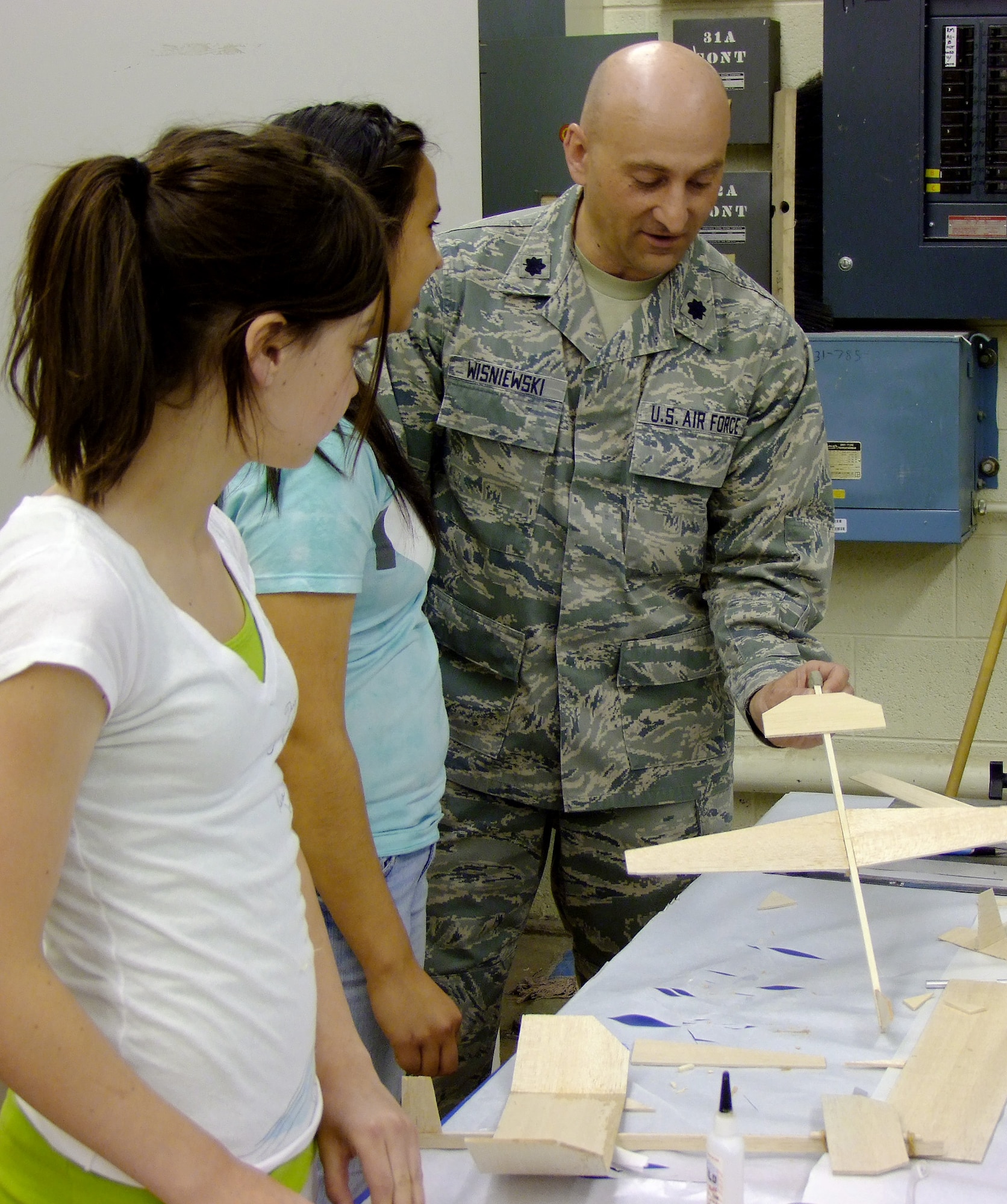 Lt. Col. Charles Wisniewski works with two teens on model gliders June 7, 2011, at the Air Force Academy, Colo. (U.S. Air Force photo/Leslie Finstein)