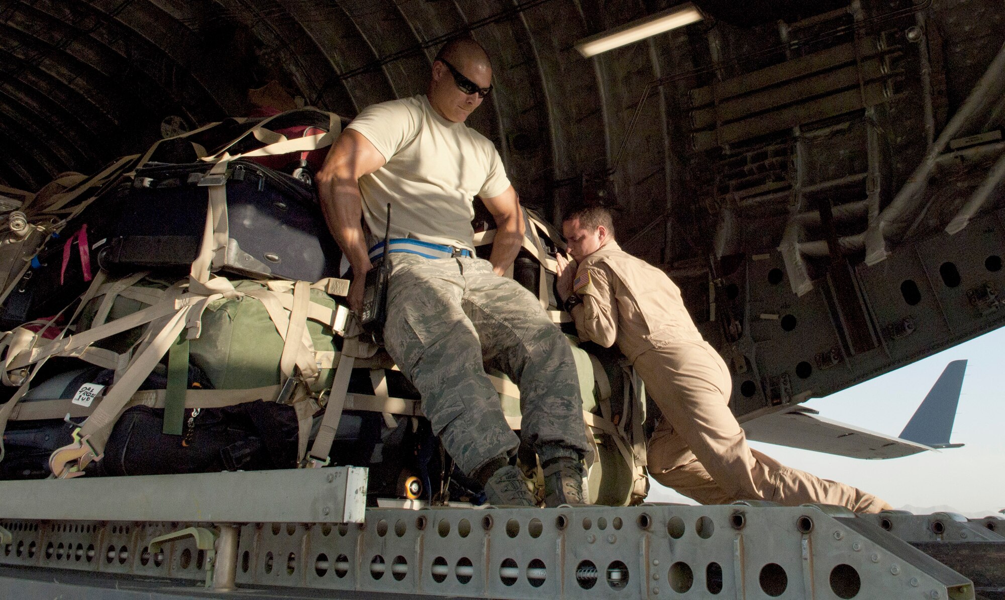 Staff Sgt. Robert Kellen and Staff Sgt. Dough Mathes push a pallet onto a C-17 Globemaster III June 13, 2011, at Bagram Airfield, Afghanistan. Sergeant Kellen is assigned to the 455th Expeditionary Aerial Port Squadron. Sergeant Mathes is assigned to the 816th Expeditionary Airlift Squadron. (U.S. Air Force photo/Senior Airman Natasha E. Stannard)