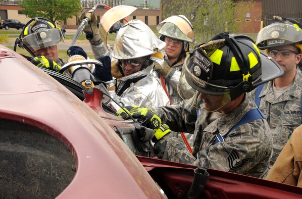 Connecticut Air National Guardsmen assigned to the 103rd Civil Engineer Squadron perform a vehicle extrication drill at Bradley Air National Guard Base, East Granby, Conn., May 14, 2011. Simulating a victim trapped inside, the Airmen use special tools to peel back the roof of the vehicle to free the victim from the wreckage. (U.S. Air Force photo by Airman 1st Class Emmanuel Santiago)