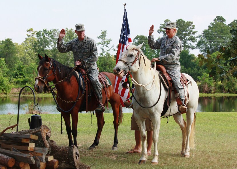 Lt. Col. Davis Maulding, 2nd Comptroller Squadron commander, reenlists Tech. Sgt. Leslie Wagner, 2 CPTS, while on horseback at Sergeant Wagner's farm in DeBerry, Texas, June 10. Sergeant Wagner is a country girl at heart and could think of no better way to make the occasion a more memorable one. (Courtesy photo)(RELEASED)