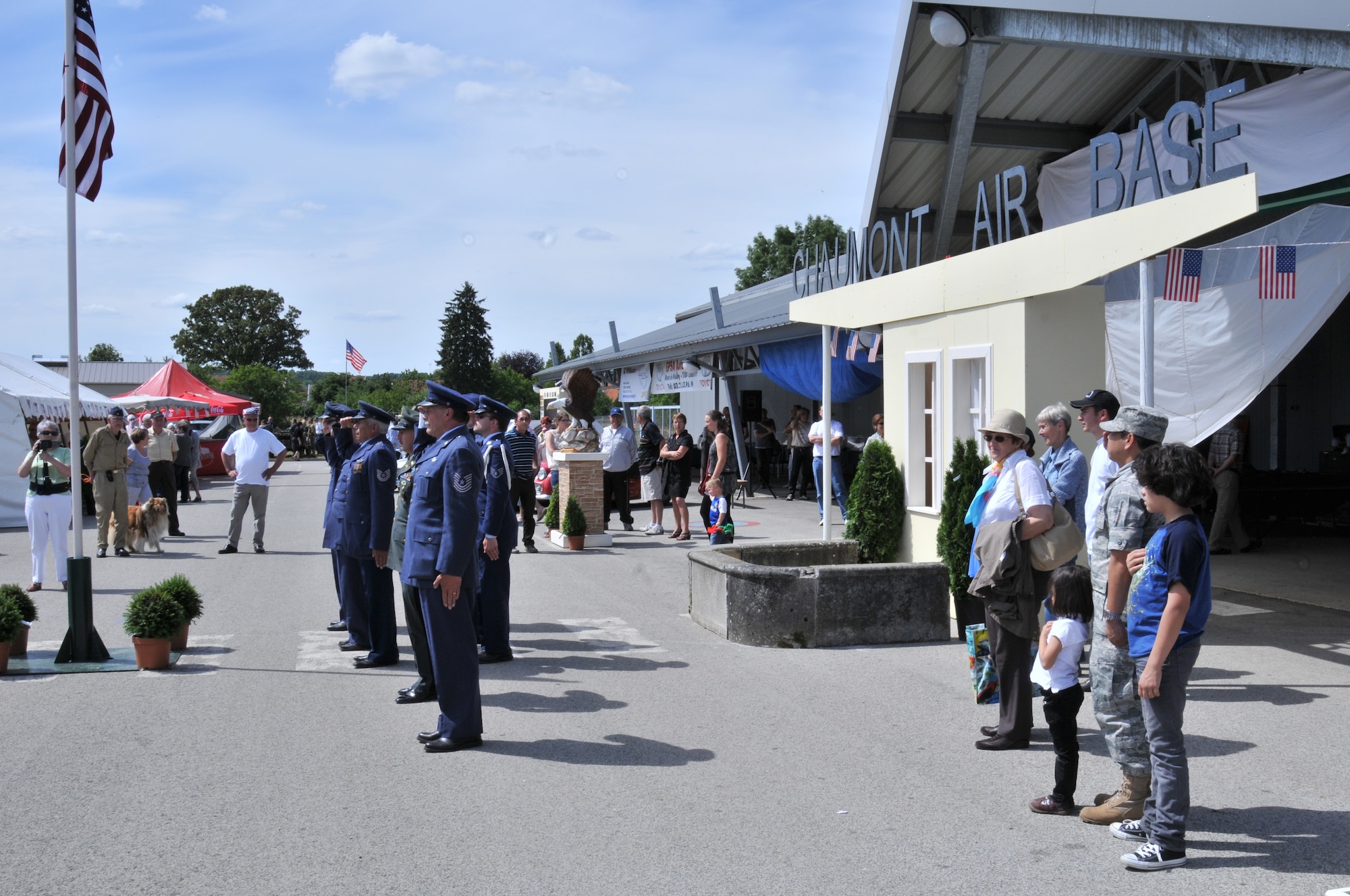 VILLIERS-LE-SEC, France -- French citizens dressed in vintage American uniforms perform a flag ceremony during an exhibition celebrating the former Chaumont Air Base, June 12, 2011. The 48th Fighter Bomber Wing operated the base from 1952 to 1967 before moving to RAF Lakenheath, England. (U.S. Air Force photo/Senior Airman David Dobrydney)