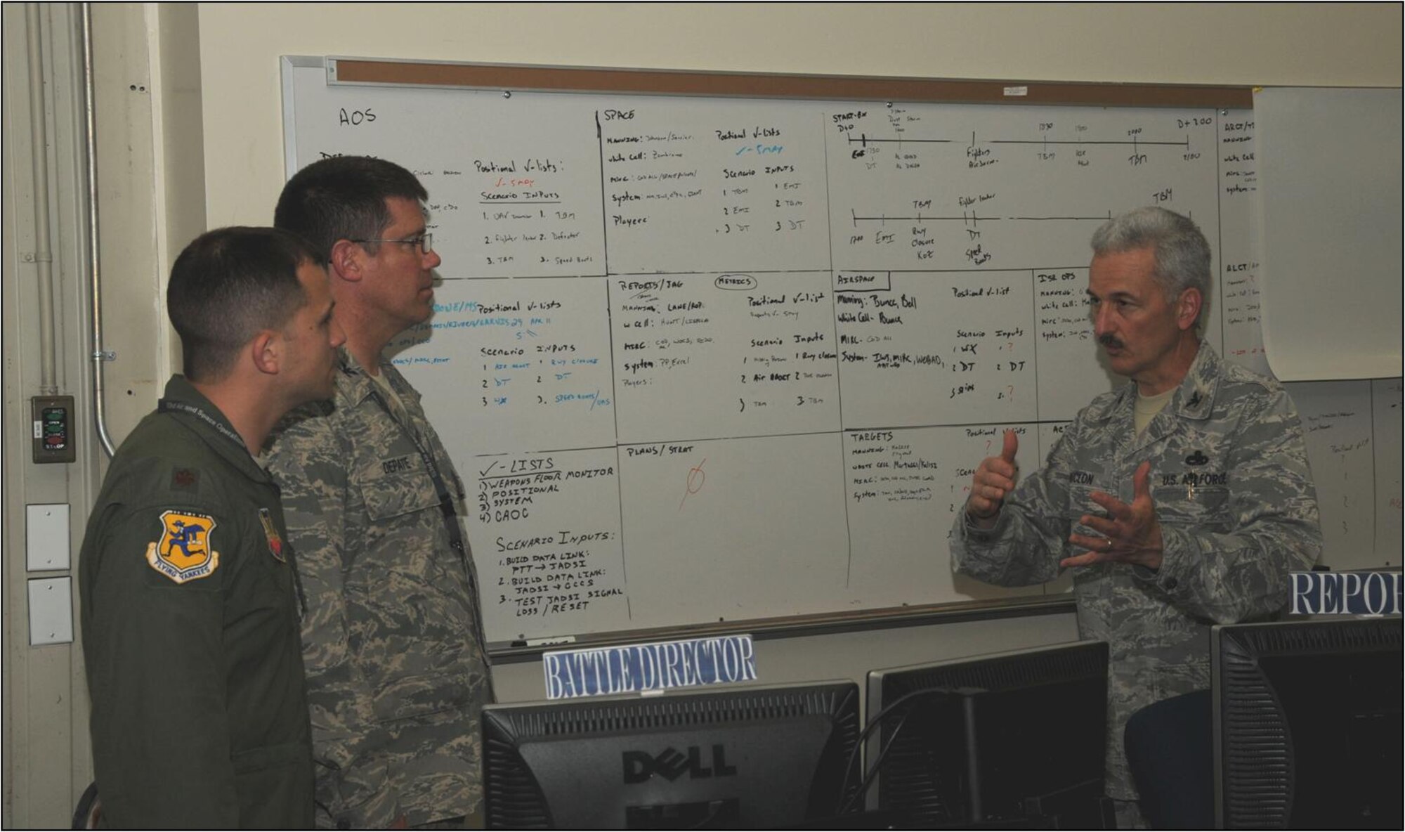 Maj. Evan Hunt and Col. Peter DePatie, both of the 103rd Air and Space Operations Group, discuss exercise integration on the AOG's operations floor with 103rd Airlift Wing vice commander, Col. Fred Miclon, at Bradley Air National Guard Base, East Granby, Conn. May 27, 2011. (U.S. Air Force Photo by Airman 1st Class Emmanuel Santiago)