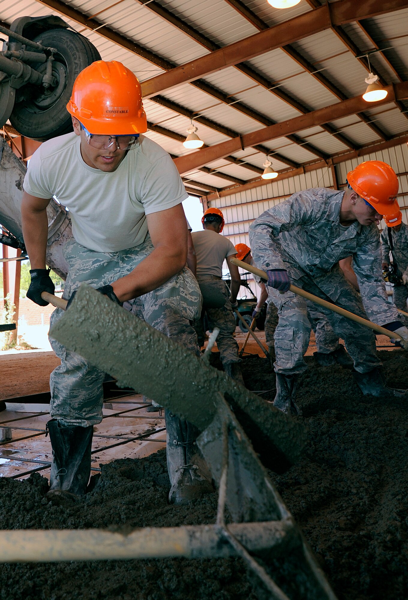 Cadet 2nd Class Sebastian Constable, left, and other cadets enrolled in the Air Force Academy's Field Engineering Readiness Laboratory construct a concrete slab June 7, 2011. FERL is a three-week course required for cadets majoring in civil or bioenvironmental engineering. Other topics covered in FERL include surveying and building roads and structures. Cadet Constable is assigned to Cadet Squadron 11. (U.S. Air Force photo/Ray McCoy)