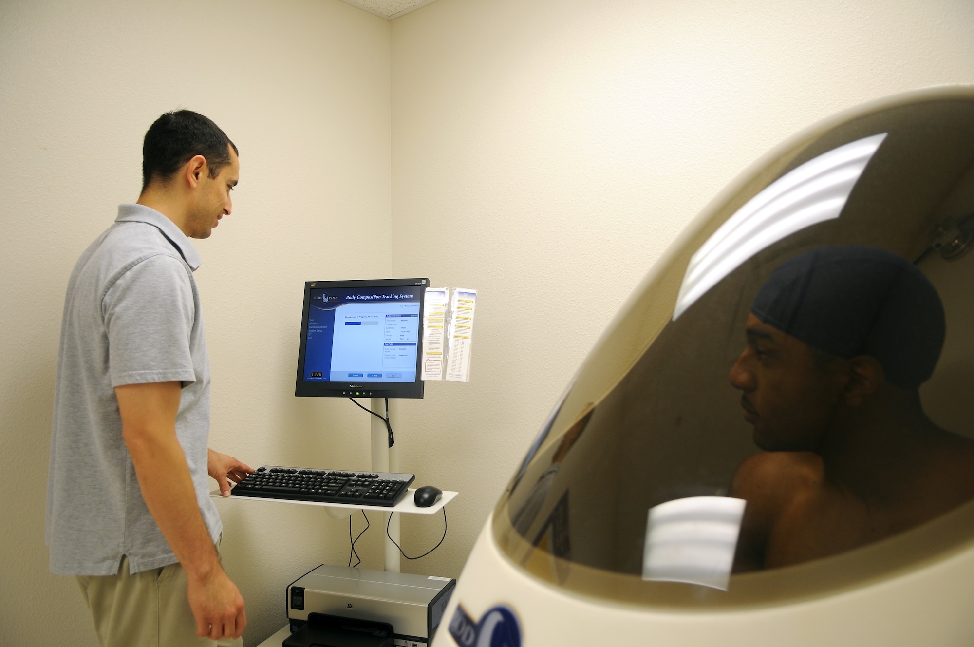 GOODFELLOW AIR FORCE BASE, Texas - Mr. Carlos Sifuentes, Health and Wellness Center health promotion educator, performs a BOD POD test on Airman 1st Class Michael Smith at the Health and Wellness Center June 10. This test will provide a breakdown of Airman Smith's body composition as well as caloric intake based on his activity level. (U.S. Air Force photo/Staff Sgt. Heather L. Rodgers)