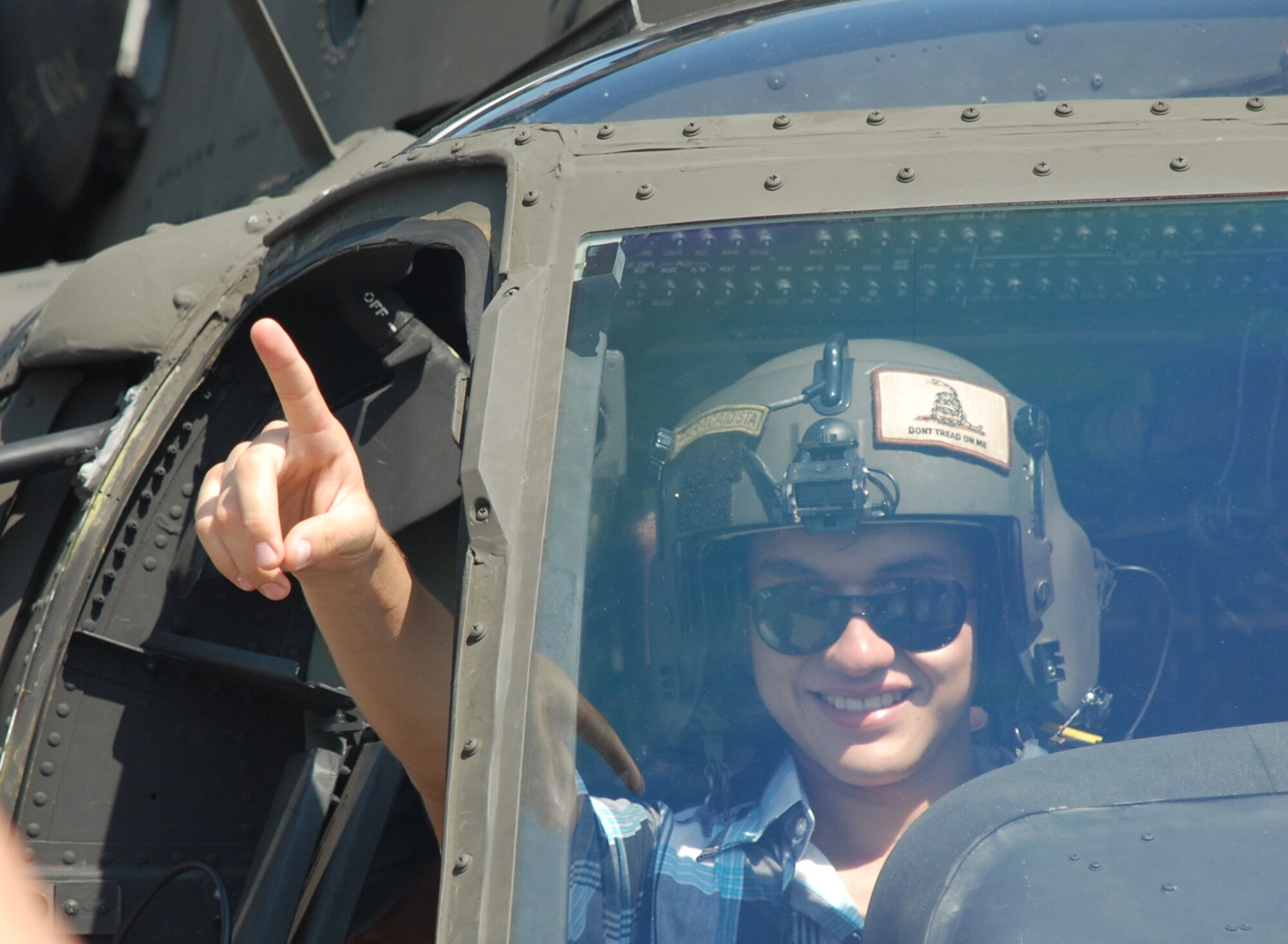 An air show participant sits in the pilot seat of a UH-60L Blackhawk June 12, 2011, at Colonel Armando Escalon Espinal Air Base, Honduras. This annual event drew more than 10,000 people, raised money for a local civilian hospital and highlights the dynamic relationship U.S. and Honduran Armed Forces share.