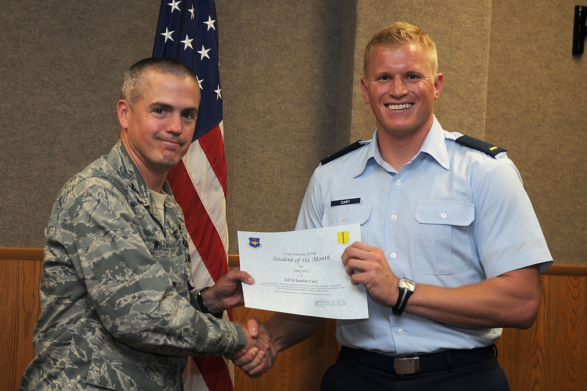 GOODFELLOW AIR FORCE BASE, Texas -- 2nd Lt. Justin Cary, 315th Training Squadron, receives a Student of the Month certificate from Col. J.D. Willis, 17th Training Group Commander, June 3, 2011. (U.S. Air Force photo/Staff Sgt. Heather Rodgers)