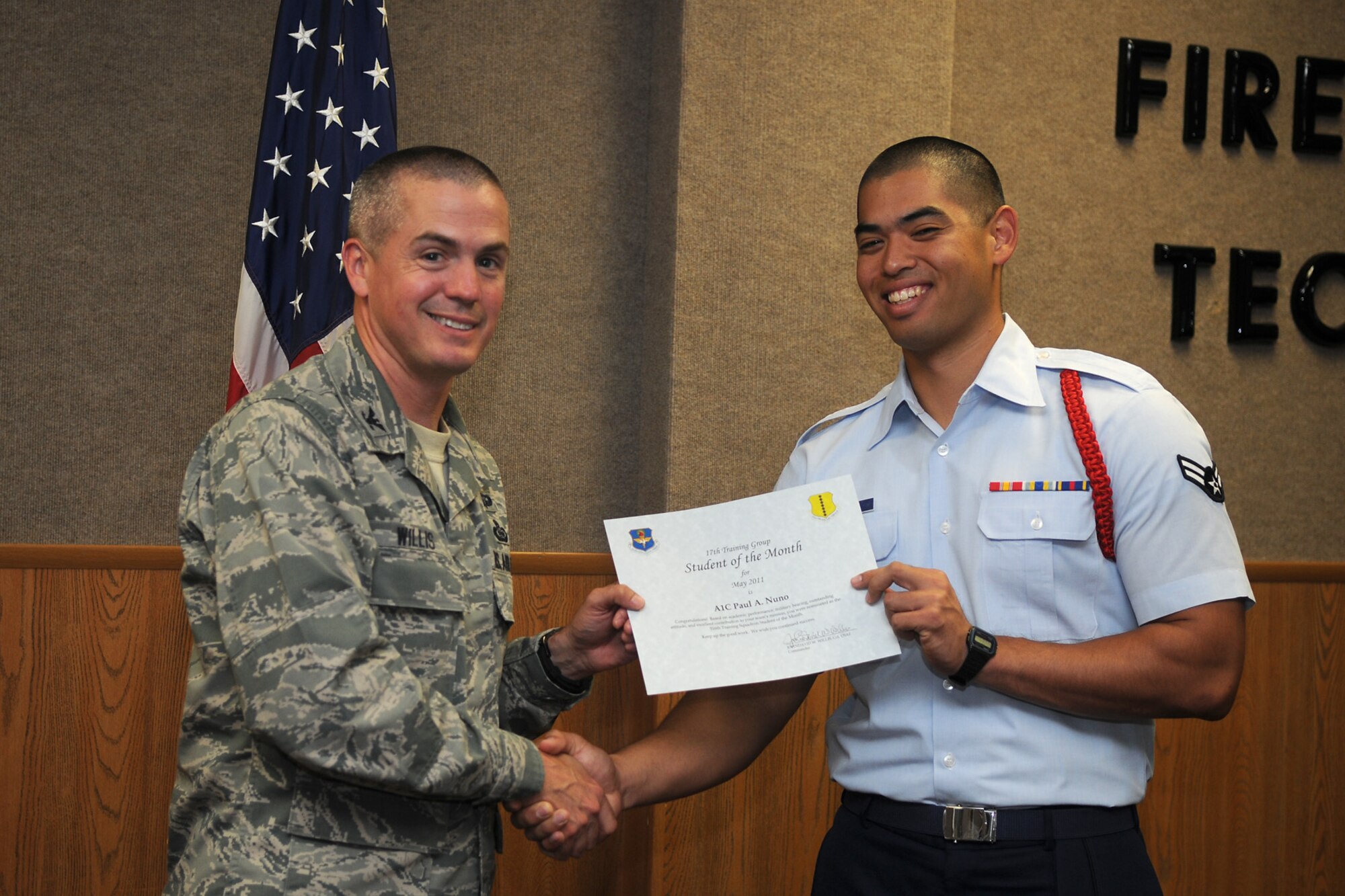 GOODFELLOW AIR FORCE BASE, Texas -- Airman 1st Class Paul Nuno, 316th Training Squadron, receives a Student of the Month certificate from Col. J.D. Willis, 17th Training Group Commander, June 3, 2011. (U.S. Air Force photo/Staff Sgt. Heather Rodgers)