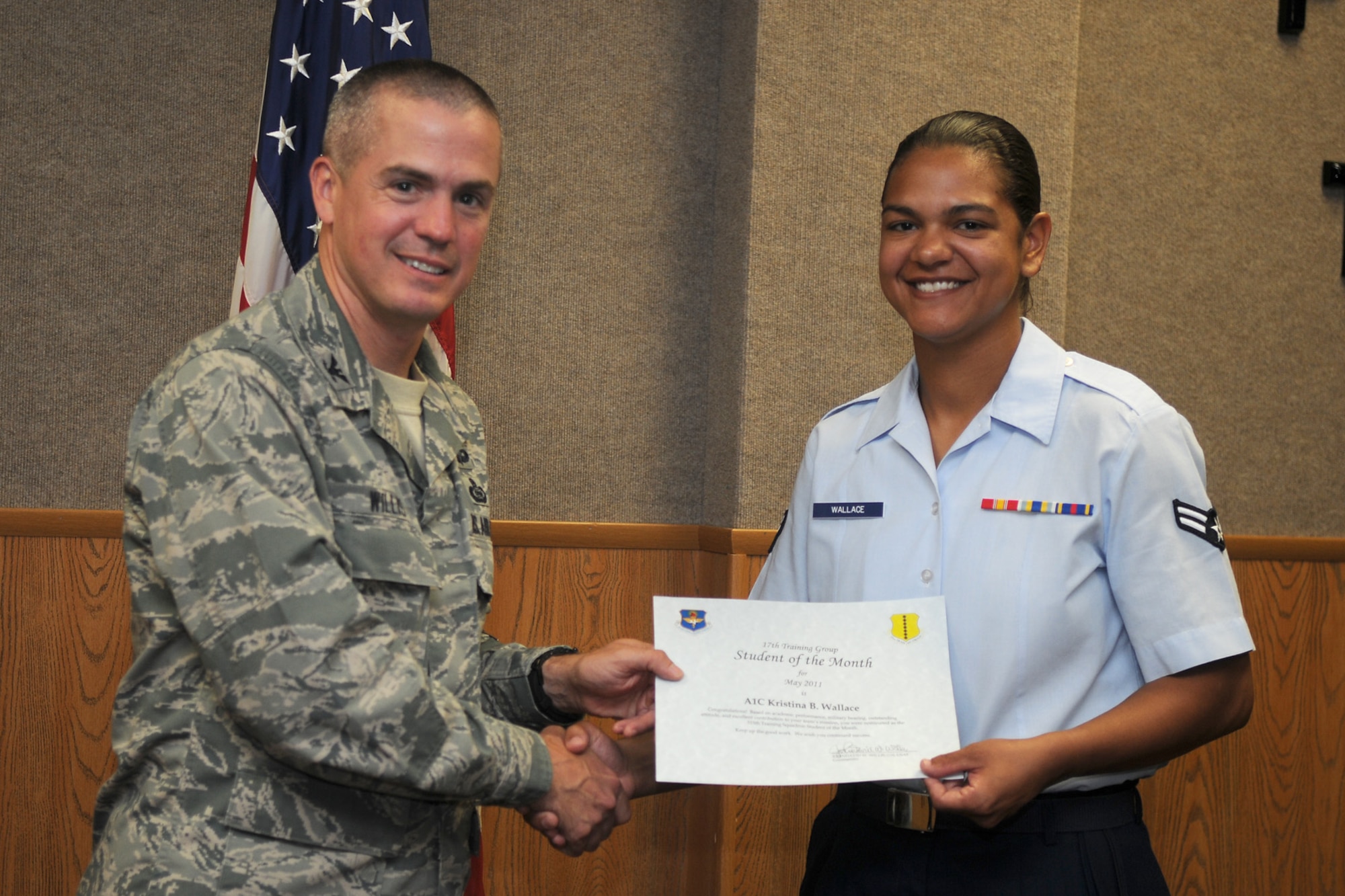 GOODFELLOW AIR FORCE BASE, Texas -- Airman 1st Class Kristina Wallace, 315th Training Squadron, receives a Student of the Month certificate from Col. J.D. Willis, 17th Training Group Commander, June 3, 2011. (U.S. Air Force photo/Staff Sgt. Heather Rodgers)
