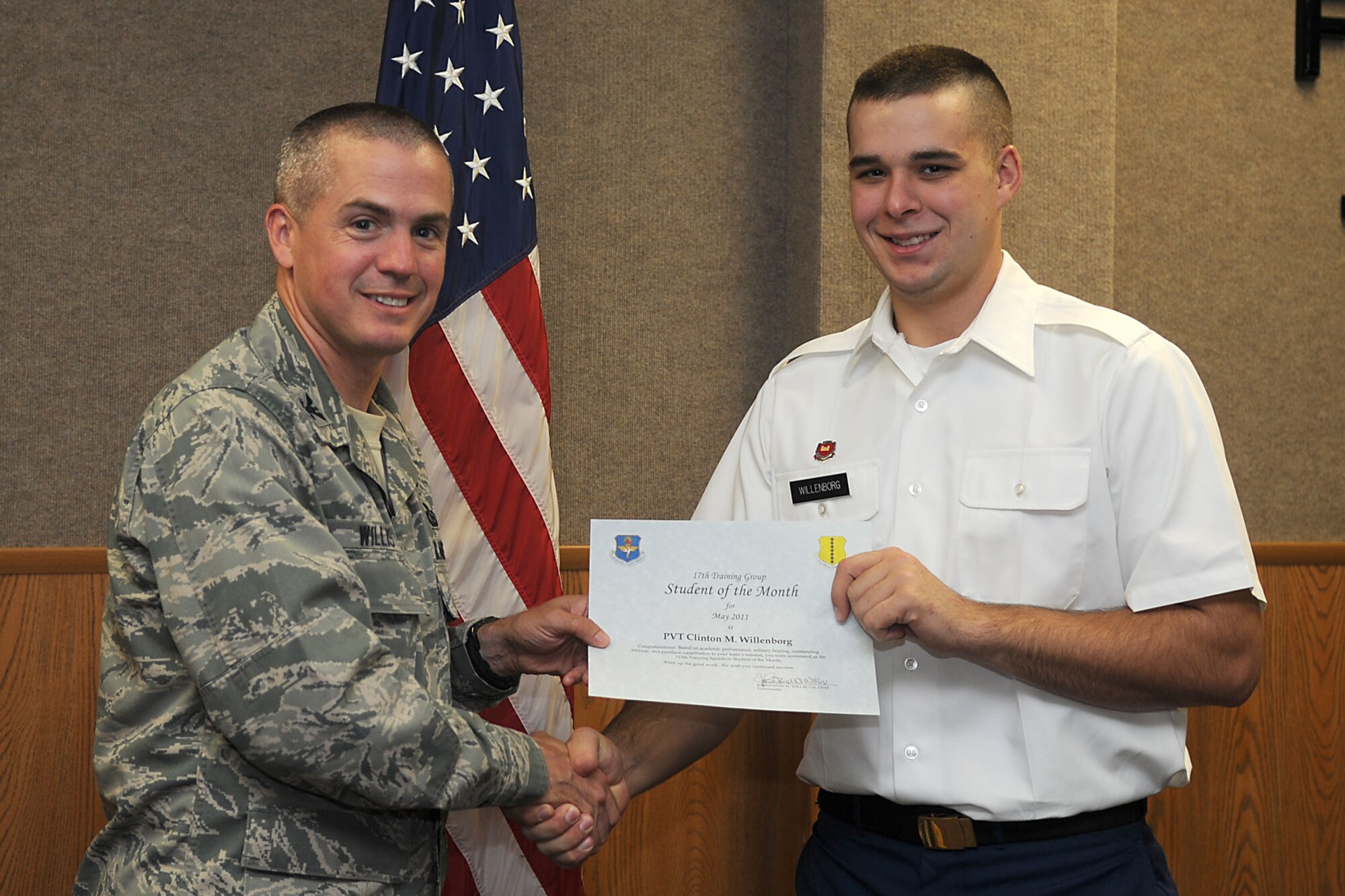 GOODFELLOW AIR FORCE BASE, Texas -- Pvt. Clinton Willenborg, 312th Training Squadron, receives a Student of the Month certificate from Col. J.D. Willis, 17th Training Group Commander, June 3, 2011. (U.S. Air Force photo/Staff Sgt. Heather Rodgers)