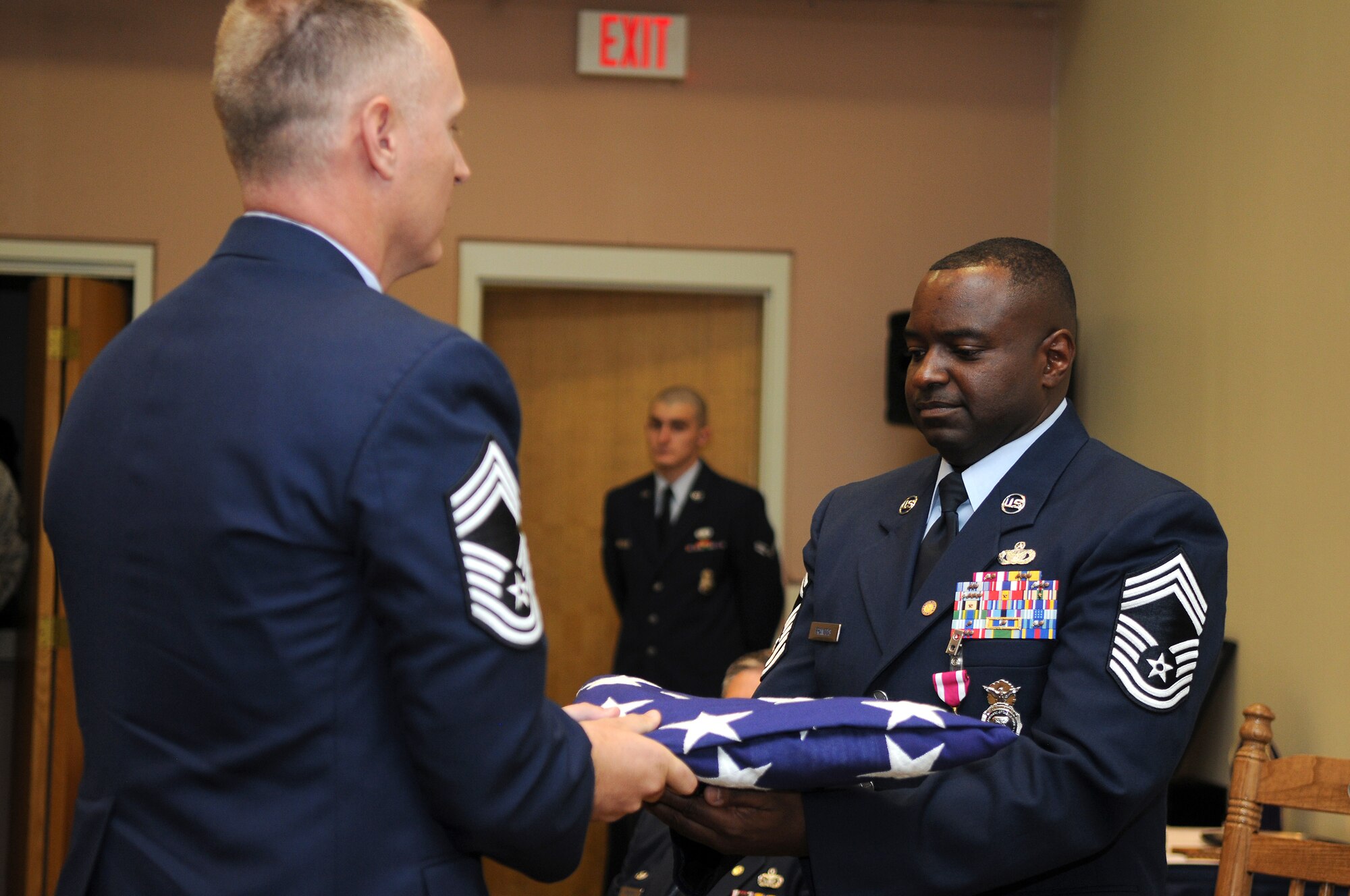 GOODFELLOW AIR FORCE BASE, Texas - Chief Master Sgt. Quinton Otto presents Chief Master Sgt. Bertell Francois, 17th Security Forces Squadron security forces manager, with an American flag at his retirement ceremony June 10. Chief Francois retired after 29 years of active duty military service as a law enforcement specialist.
(U.S. Air Force photo/Staff Sgt. Heather L Rodgers)
