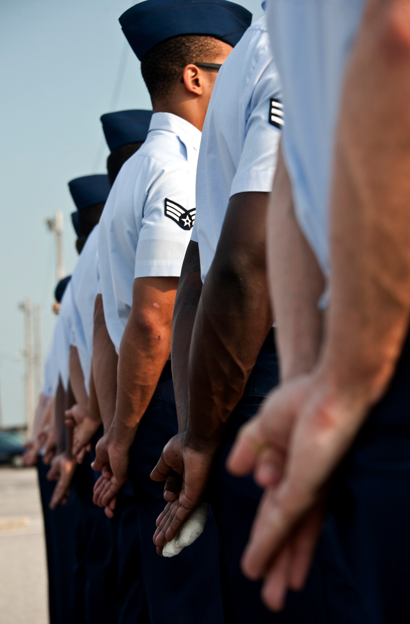 A row of Airman Leadership School students stand at parade rest prior to the morning Reveille ceremony June 13.  ALS is a five-week-long Air Force program designed to develop Airmen into effective front-line supervisors.  It is the first professional military education enlisted Air Force members encounter.  Eglin's schoolhouse hosts seven ALS classes per year.  Eglin was named Air Force Materiel Command's PME program of the year for 2009 and 2010. (U.S. Air Force photo/Samuel King Jr.)