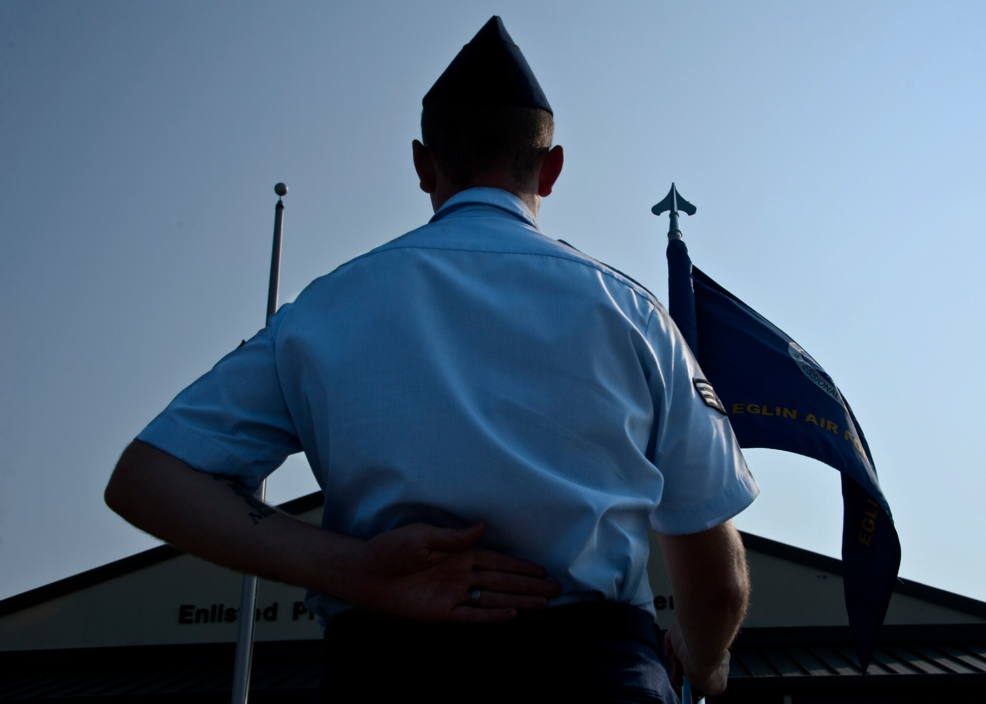 A guidon bearer stands at parade rest prior to the morning Reveille ceremony at Eglin’s Airman Leadership School June 13.  ALS is a five-week-long Air Force program designed to develop Airmen into effective front-line supervisors.  It is the first professional military education enlisted Air Force members encounter. Eglin's schoolhouse hosts seven ALS classes per year.  Eglin was named Air Force Materiel Command's PME program of the year for 2009 and 2010. (U.S. Air Force photo/Samuel King Jr.)