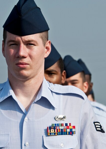 Senior Airman David Ezell, 96th Force Support Squadron, faces the flag prior to the morning Reveille ceremony at Eglin’s Airman Leadership School June 13.  ALS is a five-week-long  Air Force program designed to develop Airmen into effective front-line supervisors.  It is the first professional military education enlisted Air Force members encounter.  Eglin's schoolhouse hosts seven ALS classes per year.  Eglin was named Air Force Materiel Command's PME program of the year for 2009 and 2010. (U.S. Air Force photo/Samuel King Jr.)