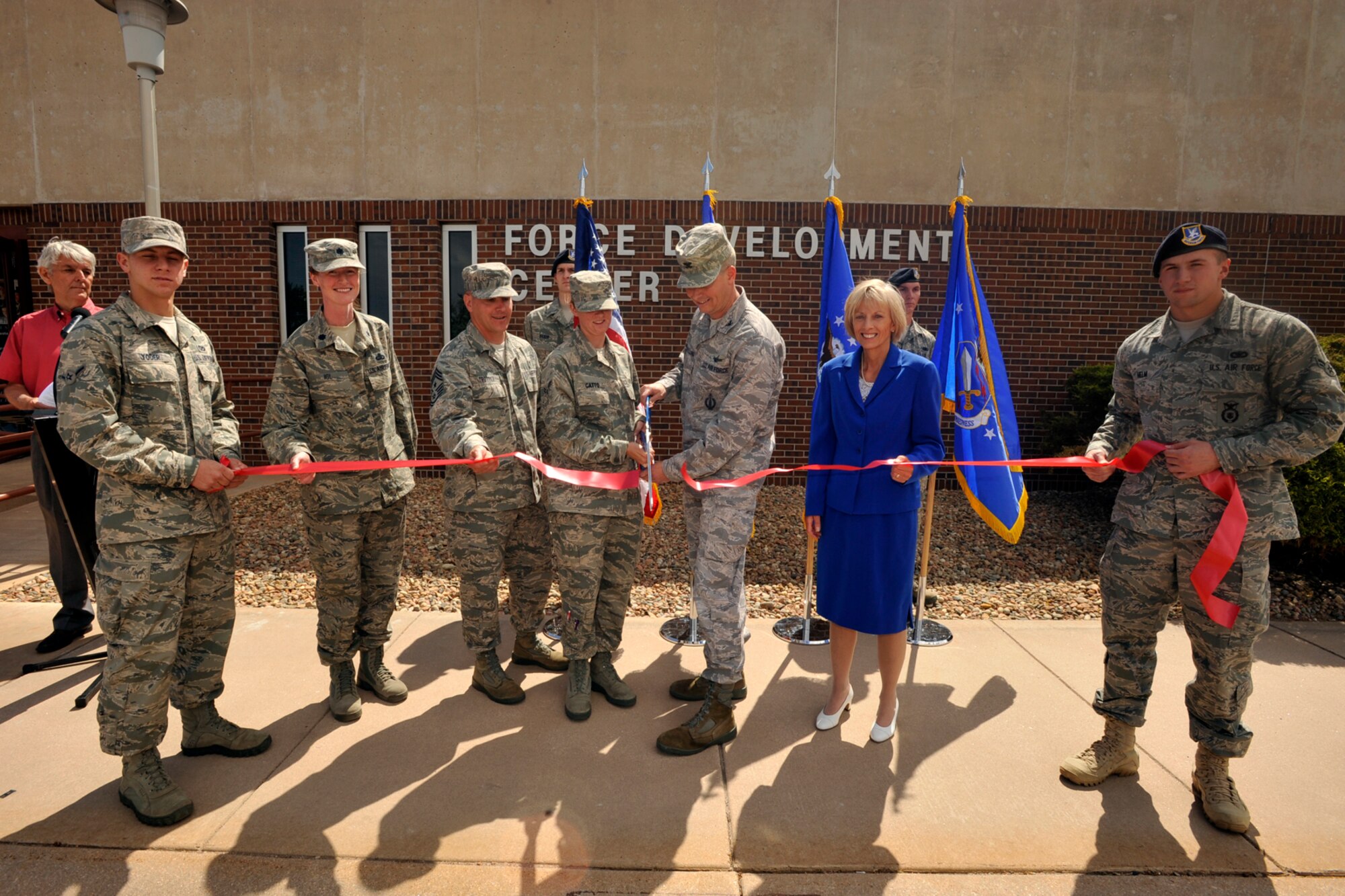 Col. Jeffrey Flewelling, 21st Space Wing vice commander and Airman Bria Gatto, 21st Force Support Squadron and currently a student at the First Term Airman Center, (both center) cut a ribbon June 10, 2011, to symbolize the official grand opening of the force development center in Building 1171, at the corner of Stewart Avenue and Vincent Street, on Peterson Air Force Base. Colonel Flewelling is flanked by (from left) Airman Michael Yoder, 21st Civil Engineer Squadron, Lt. Col. Ann Igl, 21st FSS commander, Chief Master Sgt. Thomas Trottier, 21st SW command chief, Sue Wilson, 21st Force Development flight chief, and Airman 1st Class Matthew Helm, 721st Security Forces Squadron. (U.S. Air Force photo/Dennis Howk)