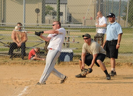 Billy Beck, 436th Comptroller Squadron left centerfielder, hits the ball during an intramural softball game against the 9th Airlift Squadron June 9, 2011, at Dover Air Force Base, Del.  CPTS/MOS defeated 9 AS 13 – 3.  (U.S. Air Force photo by Staff Sgt. Chad Padgett)