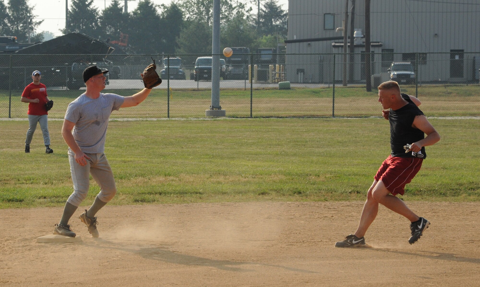 (Left) Jake Kime, 436th Comptroller Squadron shortstop, forces out Rob McGriffin, 9th Airlift Squadron, during an intramural softball game June 9, 2011, at Dover Air Force Base, Del.  CPTS/MOS defeated 9 AS 13 – 3.  (U.S. Air Force photo by Staff Sgt. Chad Padgett)