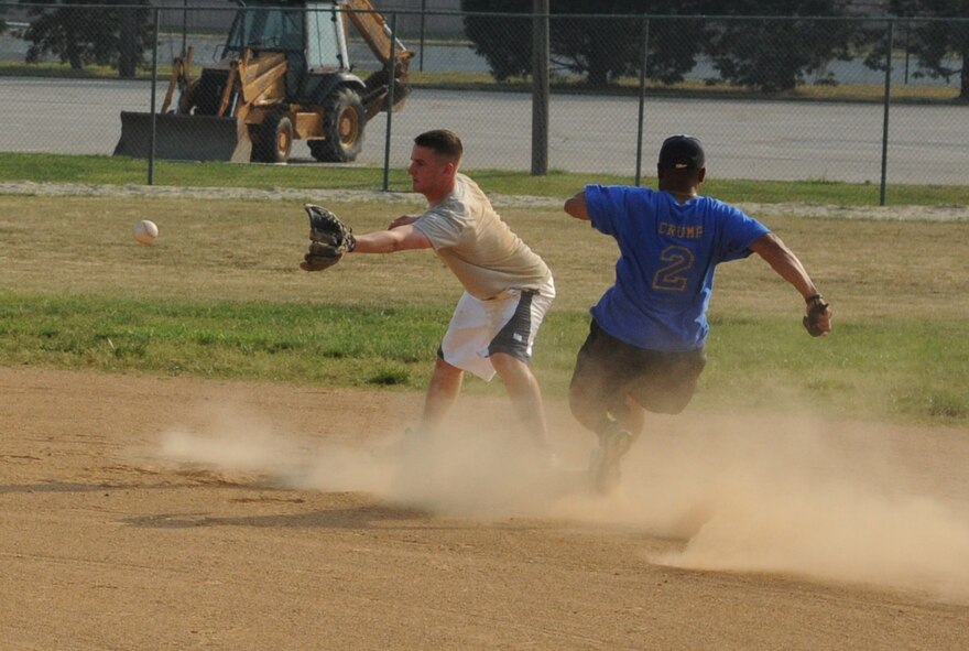 (Right)  Johnny Crump, 9th Airlift Squadron, races to second base just ahead of the ball during an intramural softball game against the 436th Comptroller Squadron June 9, 2011, at Dover Air Force Base, Del.  CPTS/MOS defeated 9 AS 13 – 3.  (U.S. Air Force photo by Staff Sgt. Chad Padgett)