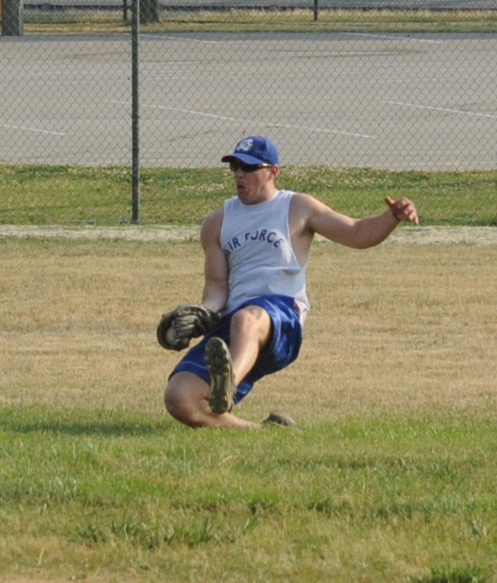Todd Early, 9th Airlift Squadron outfielder, makes a sliding catch during an intramural softball game against the 436th Comptroller Squadron June 9, 2011, at Dover Air Force Base, Del.  CPTS/MOS defeated 9 AS 13 – 3.  (U.S. Air Force photo by Staff Sgt. Chad Padgett)