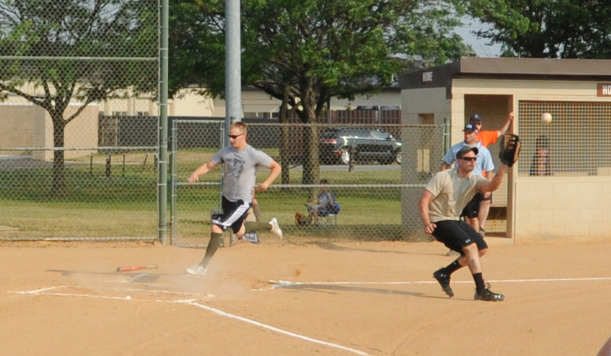 Aaron Kind, 436th Comptroller Squadron catcher, scores a run during an intramural softball game against the 9th Airlift Squadron June 9, 2011, at Dover Air Force Base, Del.  CPTS/MOS defeated 9 AS 13 – 3.  (U.S. Air Force photo by Staff Sgt. Chad Padgett)