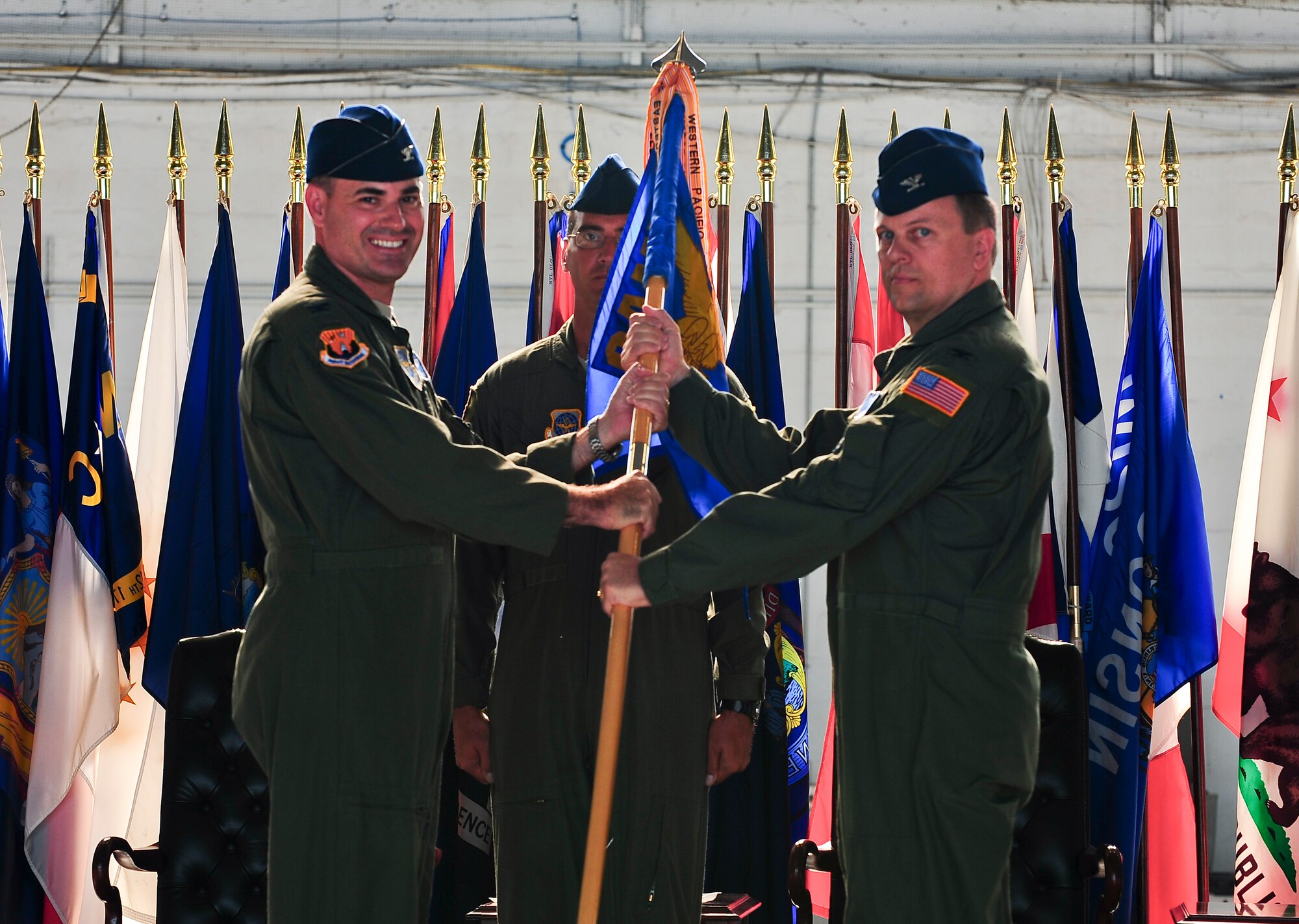 Col. Lenny Richoux, 6th Air Mobility Wing commander, passes the guideon to Col. Matthew C. Molineux, 6th Operations Group commander, during the Change of Command Ceremony at MacDill Air Force Base, Fla., June 13, 2011. Colonel Morgan relinquished his command to Colonel Matthew C. Molineux.  (US Air Force photo by Airman 1st Class Melanie Bulow-Gonterman/Released)