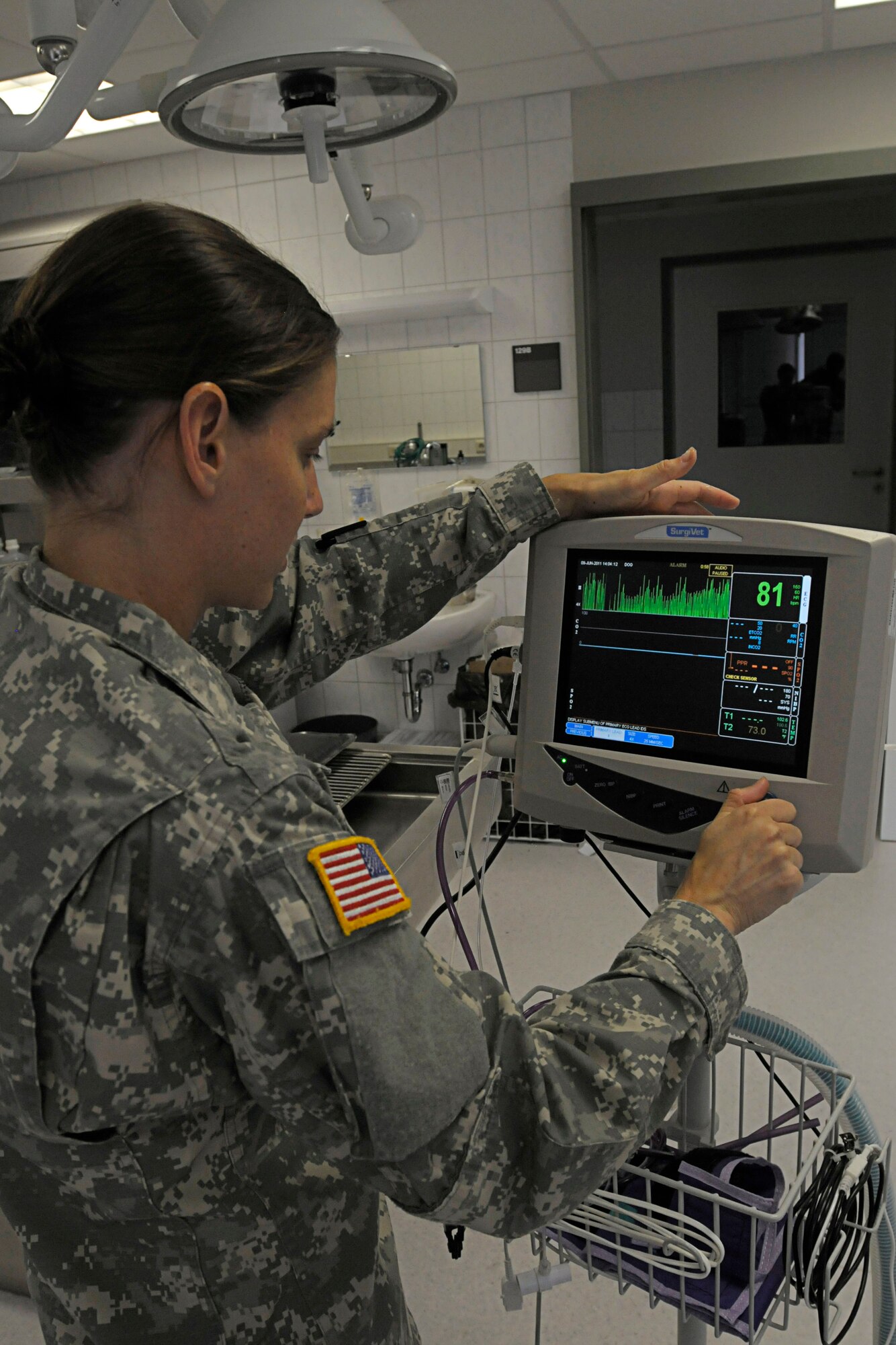U.S. Army Spc. Bethany Schilling, Dog Center Europe veterinary technicians, configures a heart monitor in preparation for an examination on a military working dog at the Pulaski Veterinarian Clinic, Pulaski Barracks, Germany, June 9, 2011. The Kaiserslautern U.S. Army Garrison Veterinary Treatment Facility is professionally staffed by Army Veterinary Corps personnel with the primary mission of providing complete medical care for all government owned animals. (U.S. Air Force photo by Airman 1st Class Desiree Esposito)