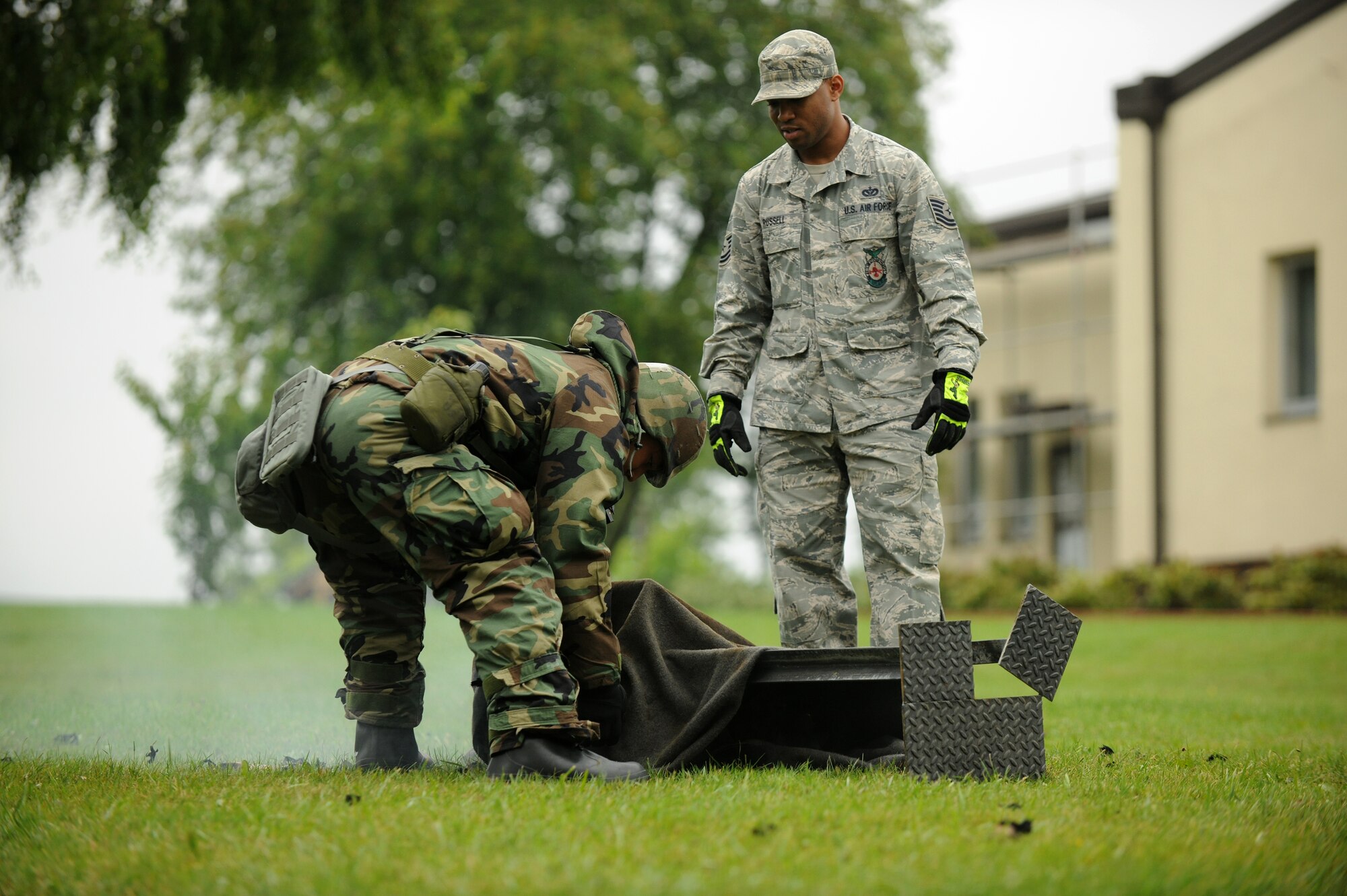 SPANGDAHLEM AIR BASE, Germany – Senior Airman Marcus Higa, 52nd Fighter Wing, extinguishes a fire on a dummy as Tech. Sgt. Shanton Russell, 52nd Civil Engineer Squadron firefighter, watches during individual core competency skills training here June 13. The training reviewed individual chemical, biological, radiological and nuclear defense; weapon familiarization; first aid; and firefighting to prepare Airmen to operate in hostile environments. (U.S. Air Force photo/Senior Airman Nathanael Callon)