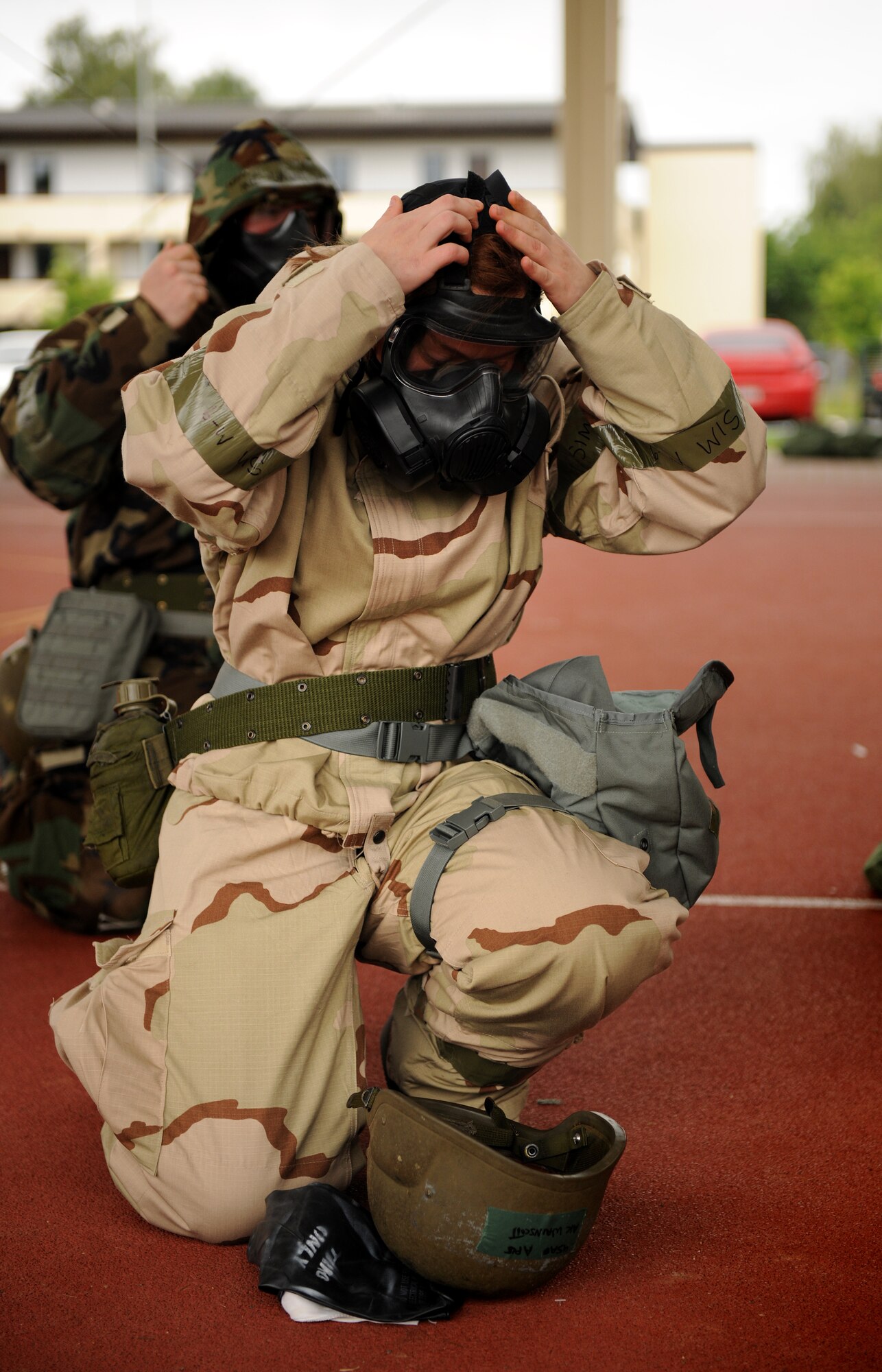 SPANGDAHLEM AIR BASE, Germany – Airman Sarah Wainscott, 52nd Force Support Squadron, dons her M-50 gas mask during individual core competency skills training here June 13. The training reviewed individual chemical, biological, radiological and nuclear defense; weapon familiarization; first aid; and firefighting to prepare Airmen to operate in hostile environments. (U.S. Air Force photo/Senior Airman Nathanael Callon)