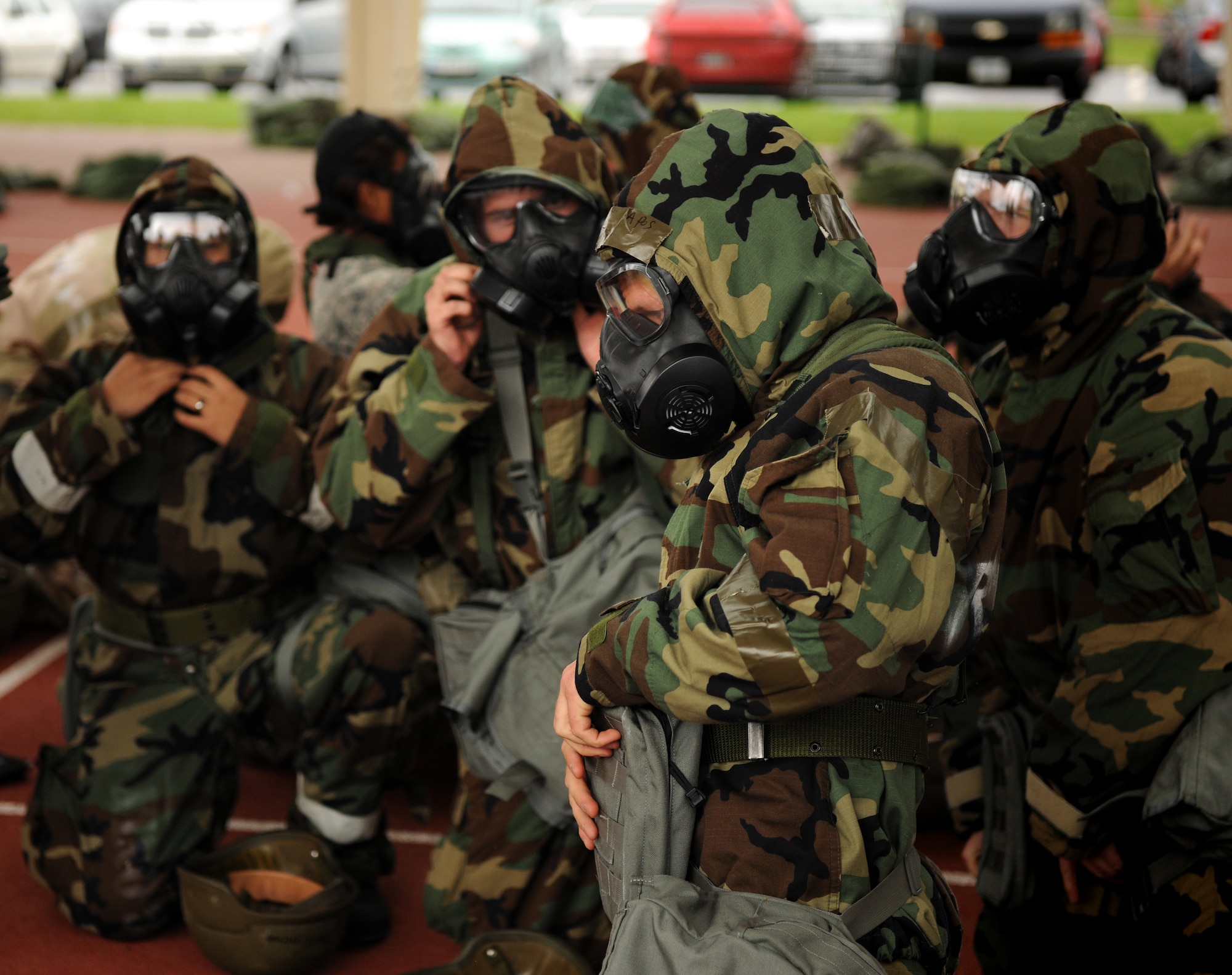 SPANGDAHLEM AIR BASE, Germany – Airmen from the 52nd Fighter Wing don their mission-oriented protective posture gear during individual core competency skills training here June 13. The training reviewed individual chemical, biological, radiological and nuclear defense; weapon familiarization; first aid; and firefighting to prepare Airmen to operate in hostile environments. (U.S. Air Force photo/Senior Airman Nathanael Callon)