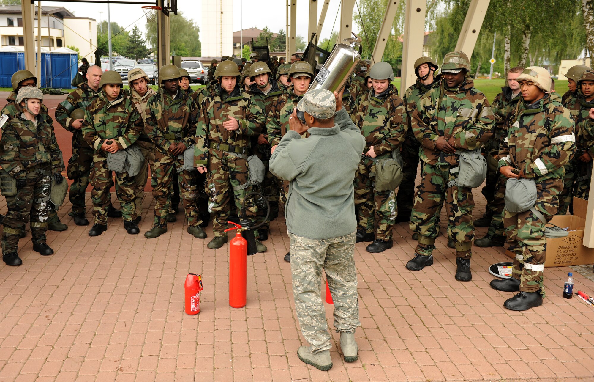 SPANGDAHLEM AIR BASE, Germany – Tech. Sgt. Daniel Robinson, 52nd Civil Engineer Squadron firefighter, explains the differences between various types of fire extinguishers during individual core competency skills training here June 13. The training reviewed individual chemical, biological, radiological and nuclear defense; weapon familiarization; first aid; and firefighting to prepare Airmen to operate in hostile environments. (U.S. Air Force photo/Senior Airman Nathanael Callon)