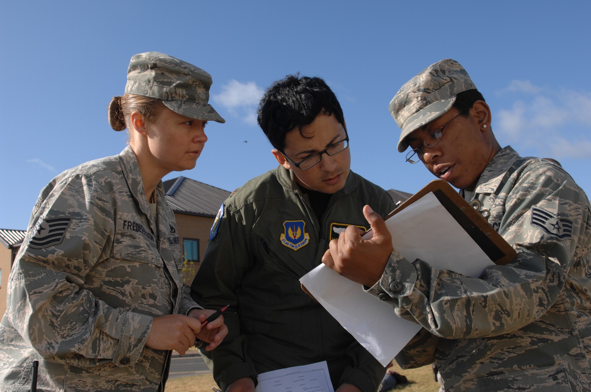 ROYAL AIR FORCE LAKENHEATH, England -- Tech. Sgt. Carrie Frederickson, 48th Civil Engineer Squadron fire inspector, Maj. Carlos Enamorado  48th Aerospace Medicine Squadron flight surgeon and Staff Sgt. Tina Celestine, 48th AMDS medical administrator triage victims during an emergency response and mass casualty exercise, June 8, 2011.  Airmen from the 48th Fighter Wing responded to the incident after a simulated fuel line ruptured, spilling more than 15,000 gallons of jet fuel and causing a collision between a bus, a privately owned vehicle and a group of Airmen participating in physical training.  The purpose of the exercise was to validate and evaluate multiple procedures when responding to such a scenario.  (U.S. Air Force photo /Tech. Sgt. Lee A. Osberry Jr.)