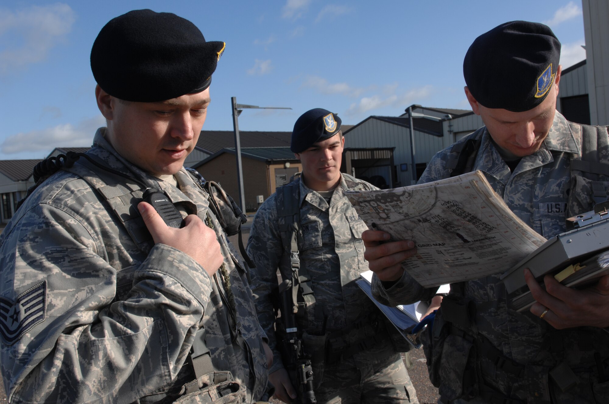 ROYAL AIR FORCE LAKENHEATH, England -- Tech. Sgt. James Wrisley (left) , 48th Security Forces Squadron flight chief, passes information regarding the scene during an emergency response and mass casualty exercise, June 8, 2011.  Airmen from the 48th Fighter Wing responded to the incident after a simulated fuel line ruptured, spilling more than 15,000 gallons of jet fuel and causing a collision between a bus, a privately owned vehicle and a group of Airmen participating in physical training.  The purpose of the exercise was to validate and evaluate multiple procedures when responding to such a scenario.  (U.S. Air Force photo /Tech. Sgt. Lee A. Osberry Jr.)