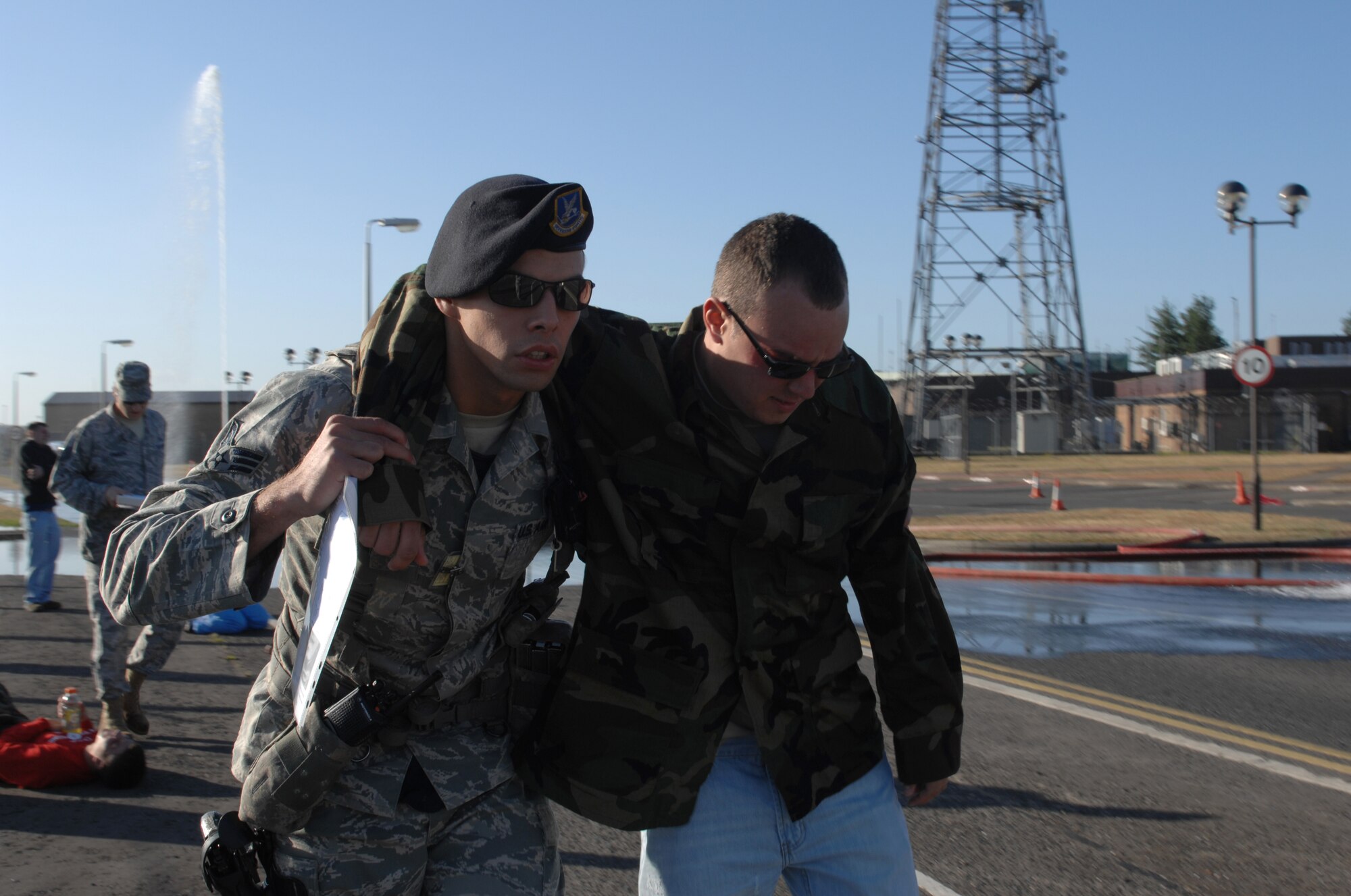 ROYAL AIR FORCE LAKENHEATH, England -- Senior Airman Patrick Whaley, 48th Security Forces Squadron patrolman, removes a victim from the area, during an emergency response and mass casualty exercise, June 8, 2011. Airmen from the 48th Fighter Wing responded to the incident after a simulated fuel line ruptured, spilling more than 15,000 gallons of jet fuel and causing a collision between a bus, a privately owned vehicle and a group of Airmen participating in physical training.  The purpose of the exercise was to validate and evaluate multiple procedures when responding to such a scenario.  (U.S. Air Force photo /Tech. Sgt. Lee A. Osberry Jr.)