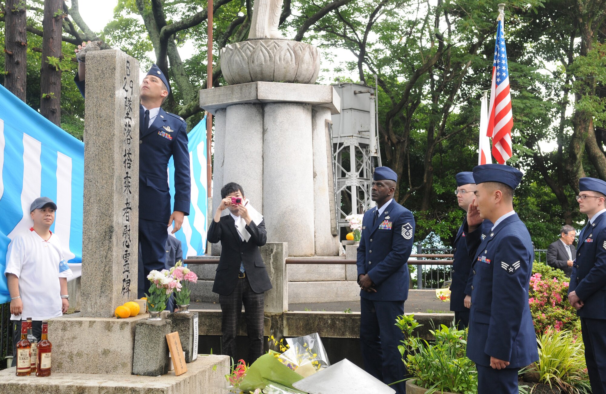 SHIZUOKA CITY, Japan -- Several members of Yokota Air Base, Japan, came out to pay their respects during the B-29 remembrance ceremony held in Shizuoka City, Japan, by pouring whiskey on the shrine June 11, 2011. Members from Yokota attended the ceremony that honors the 23 fallen aircrew that died June 20, 1945, when two B-29s collided mid-air during an air raid on the city. (U.S. Air Force photo/Airman John D. Partlow)
