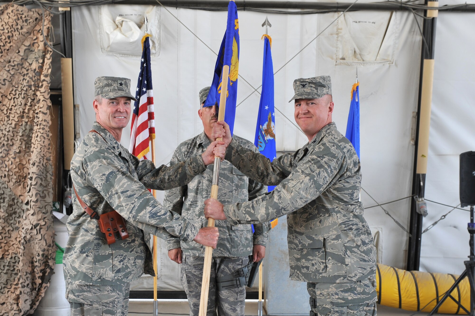 Brig. Gen. Darryl Roberson, 455th Air Expeditionary Wing commander, passes
the guidon to Col. Geoffrey Bacon during the 455th Expeditionary Maintenance
Group change of command ceremony at Bagram Airfield, Afghanistan, June 10,
2011. Colonel Bacon assumed command from Col. Tom Miller. (U.S. Air Force
photo by Senior Airman Sheila deVera)
