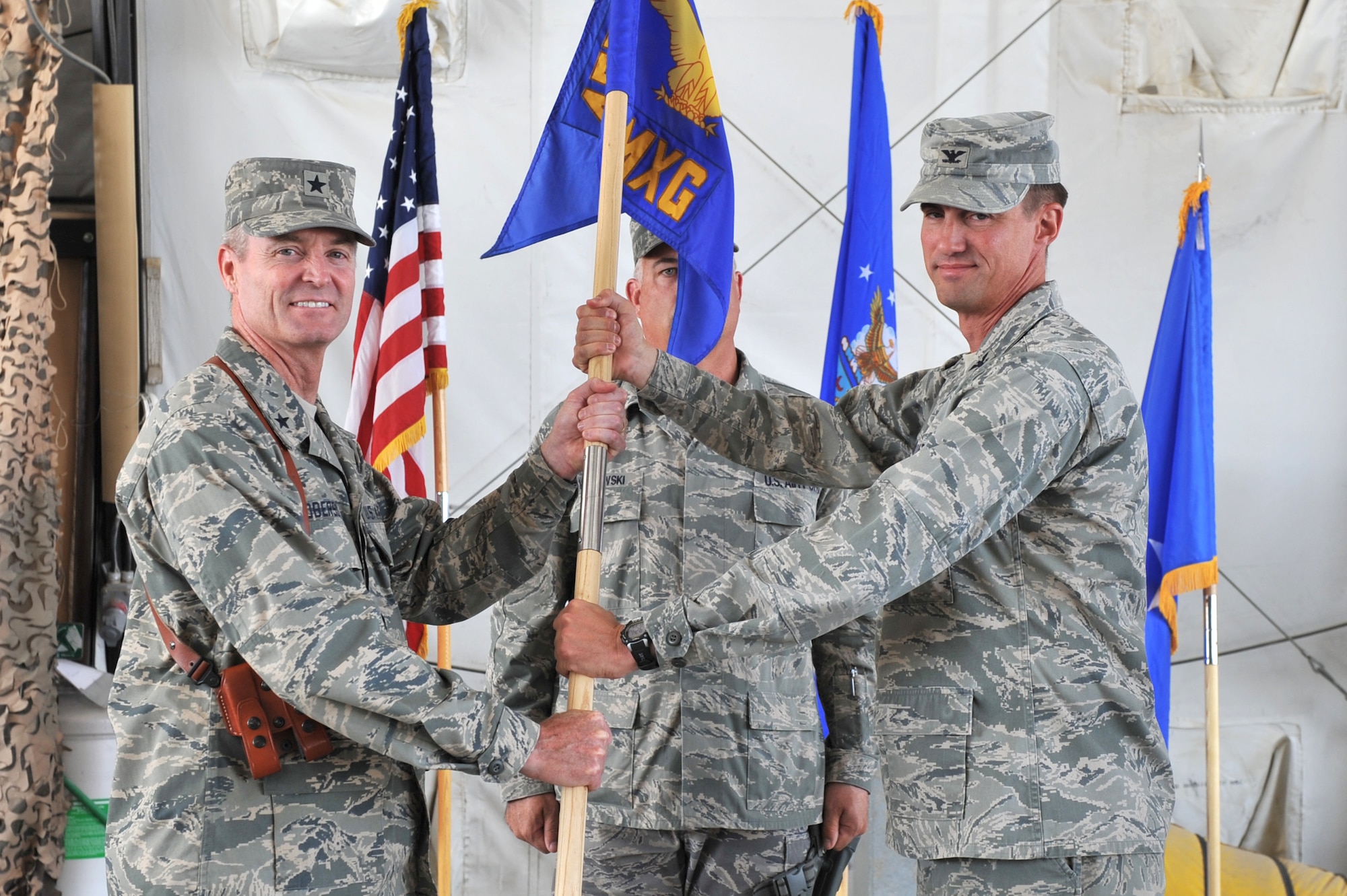 Col. Tom Miller, 455th Expeditionary Maintenance Group commander, relinquishes
command to Brig. Gen. Darryl Roberson, 455th Air Expeditionary Wing
commander during the change of command ceremony at Bagram Airfield,
Afghanistan, June 10. 2011. (U.S. Air Force photo by Senior Airman Sheila
deVera)
