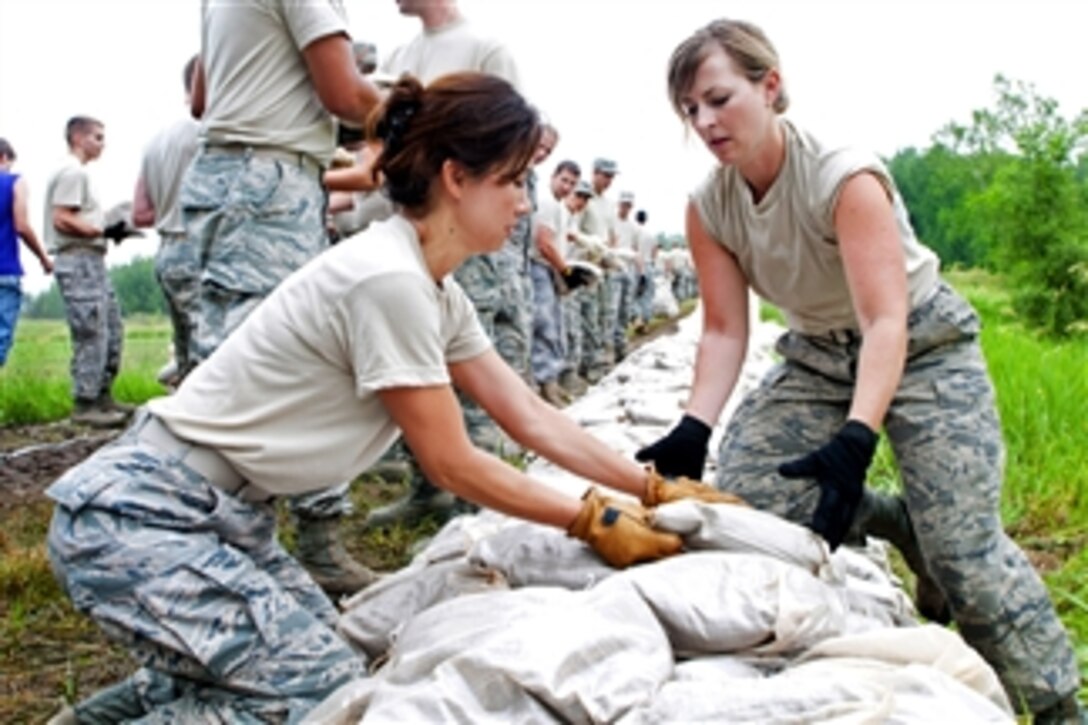 Air Force airmen lay sandbags to protect against possible flooding from the Missouri River outside Rosecrans Memorial Airport, St. Joseph, Mo., on June 10, 2011.  The airmen are assigned to the 139th Airlift Wing, Missouri Air National Guard.  Combined with the help of volunteers from local communities, the airmen helped lay 24,000 sandbags.  