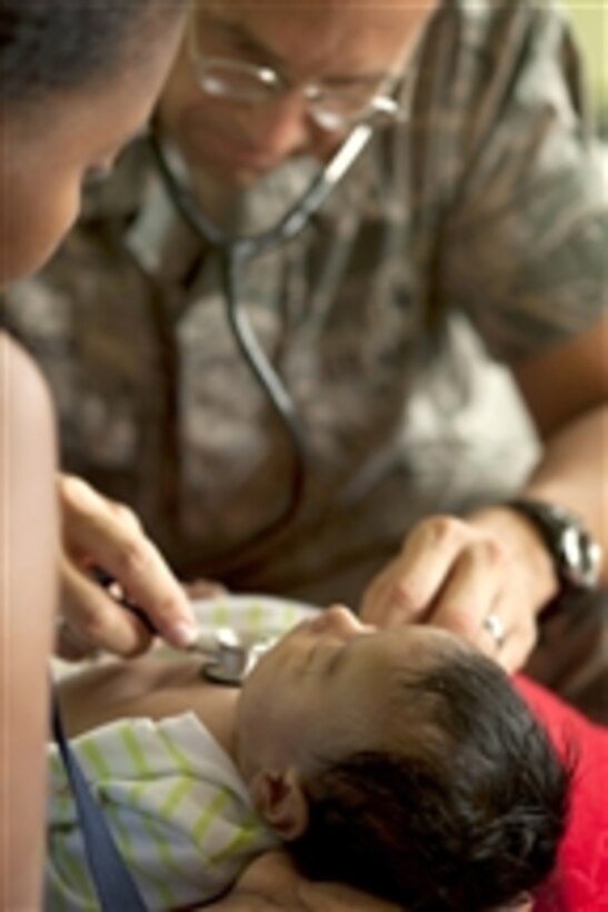 U.S. Air Force Maj. Gary Ruesch examines a young patient at the Escuela Max Seidel medical site during Continuing Promise 2011 in Tumaco, Colombia, on June 7, 2011.  Ruesch is a nurse practitioner.  